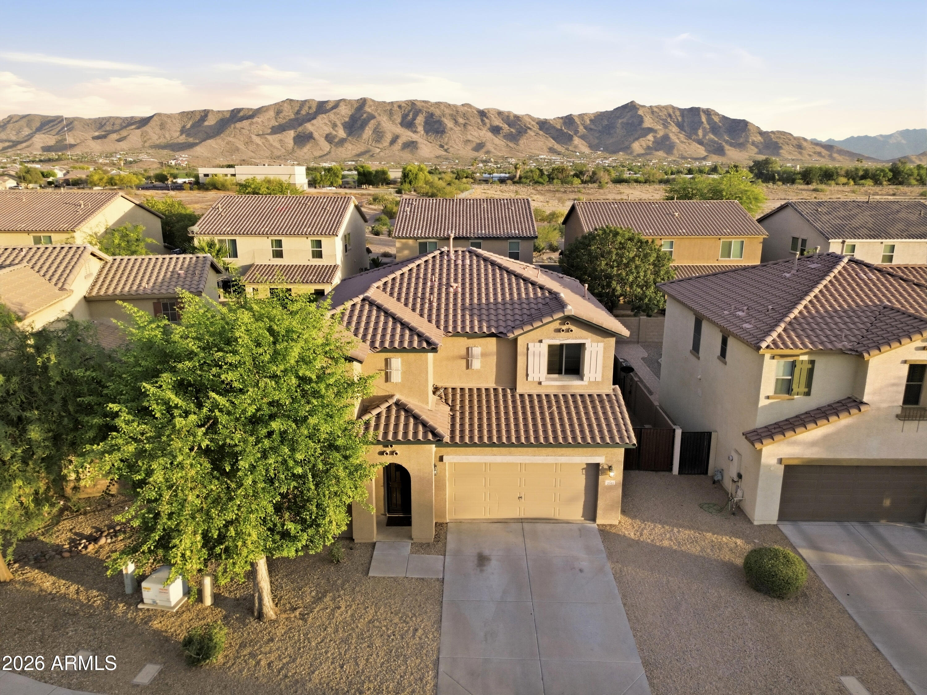 This move-in ready home is freshly painted inside and out and features tile and wood flooring throughout! The great floor plan offers formal living and dining areas, with the kitchen open to the family room and direct access to the backyard, perfect for entertaining. The kitchen includes granite countertops and a gas range. Soaring ceilings and abundant natural light create a bright, open feel throughout the home. Oversized bedrooms and 2.5 bathrooms provide plenty of space, along with a large laundry room conveniently located separate from the garage entry. The lush backyard features mature landscaping, cool natural grass, and beautiful mountain views and RV Gate & garage service door. Ideally located just mins from South Mountain Park/ Preserve for hiking, biking, and horseback riding with quick access to freeways, downtown, ASU, the airport, and both the east and west valleys.