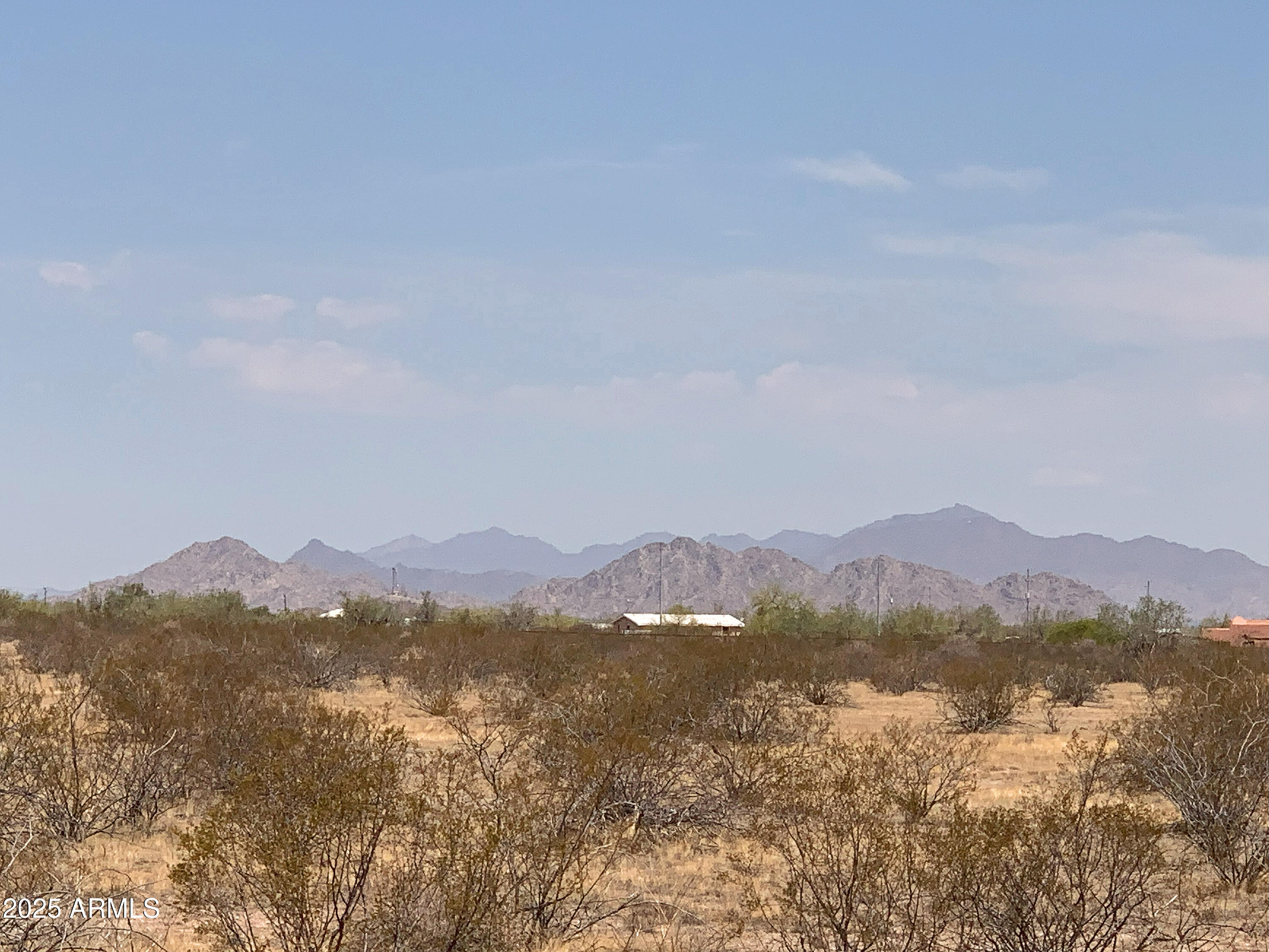 Discover Hidden Valley Estates in Maricopa, Arizona! Lot 2 of FIVE available parcels on paved Whirly Bird Road. This 1.26-acre equestrian lot boasts stunning mountain views, and seller financing may be available! Access hauled water through Maricopa Mountain Water Co. membership—ask your agent for details. Enjoy wide-open spaces with GR (General Rural) zoning, requiring a minimum 1.25 acres, so the parcel cannot be split. Experience fresh air, desert beauty, paved roads, and tranquility without city noise, yet near all amenities. Embrace country living in Maricopa—fall in love today! *Note: 2024 taxes prorated from original parcel; MLD available in documents & photos tab.