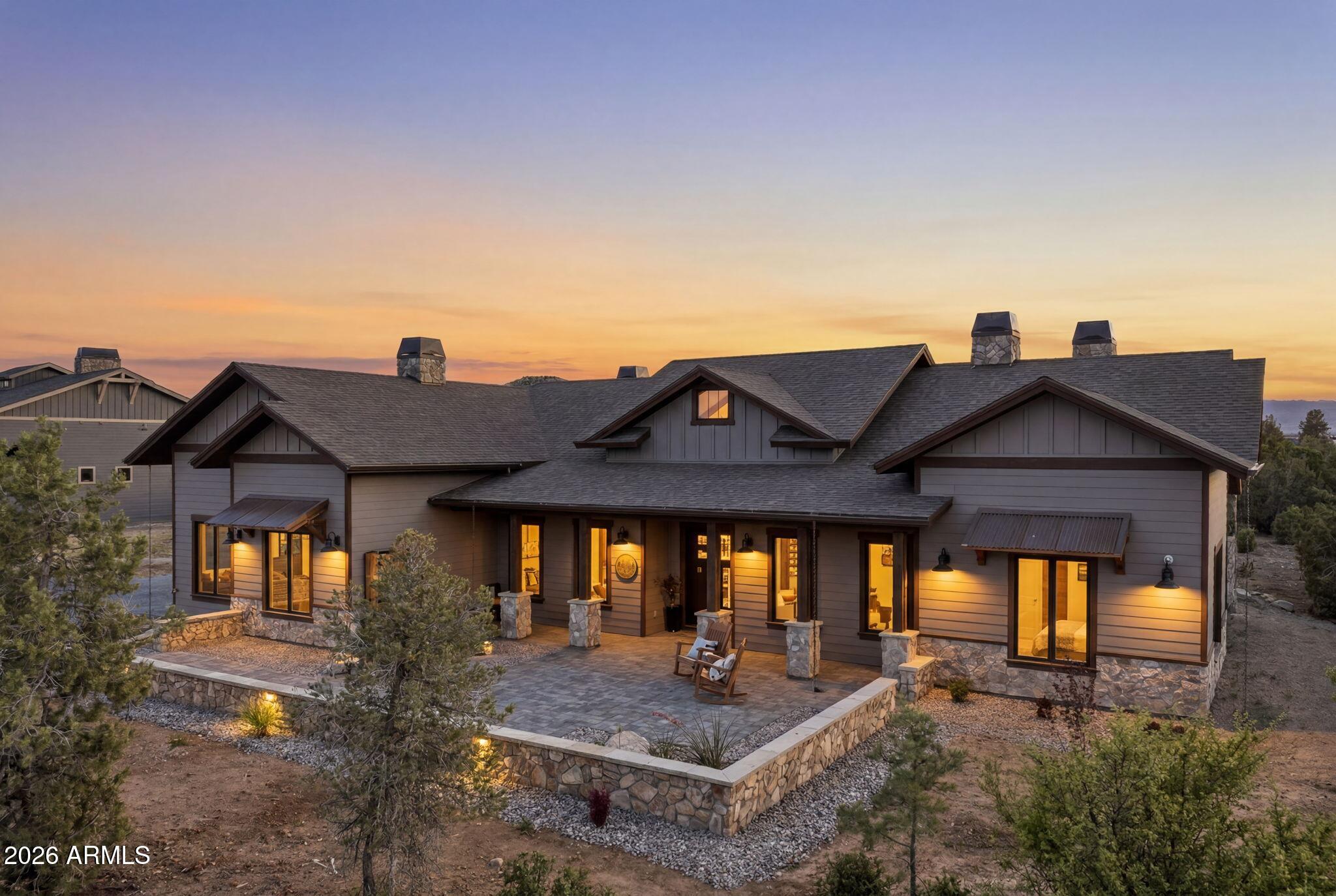 Stunning Designer Home in Talking Rock Ranch - Offered Fully Furnished Welcome to this gorgeous, modern home completed August 2025, located in the gated Talking Rock Ranch Golf Community, a private and serene neighborhood in Prescott. Perfectly positioned on a rare double lot spanning over one acre, this exceptional residence offers privacy, luxury, and thoughtful design throughout. The home features three bedrooms, three full bathrooms, and a powder room, along with a spacious three-car garage finished with epoxy floors, quiet doors, and extensive storage. From the moment you arrive, the dramatic steel and glass pivot-style front door opens into a wide, light-filled foyer that immediately showcases the home's designer aesthetic and high-end finishes. Offered fully furnished! The heart of the home is the open-concept kitchen and family room, anchored by a breathtaking floor-to-ceiling accent fireplace with custom tile work, handcrafted mantle, floating shelves, and beautifully coordinated flooring. The chef's kitchen is a true showpiece, featuring an oversized waterfall island with black quartz countertops, under-cabinet lighting, and an impressive 34 pull-out drawers with soft-close doors and drawers throughout. High-end Wolf appliances include double ovens, a four-burner range with griddle and self starting kitchen hood, pot filler, Wolf Microwave, Cove dishwasher, complemented by a Sub-Zero refrigerator. A large walk-in pantry with a built-in bar adds both functionality and style, making the space ideal for entertaining. Designer finishes continue throughout the home, including porcelain shower surrounds, Milgard doors and casement windows, a linear fireplace, wired surround sound, security cameras, an 85-inch TV, and a three-zone HVAC system for year-round comfort. Extensive storage and carefully curated details elevate every room, creating a home that is both beautiful and highly functional. Seamless indoor-outdoor living is enjoyed through a large covered patio, perfect for relaxing or entertaining while taking in the fresh mountain air and scenic surroundings. The patio features a tongue-and-groove finished ceiling, built-in speakers, and multiple gas stubs ready for a future barbecue or fire pit. This home is offered fully furnished with high-end designer furnishings, making it truly move-in ready, and also includes a golf cart for convenient access throughout the Talking Rock Ranch community. Life in Talking Rock Ranch offers an unparalleled lifestyle where luxury meets authenticity. Residents enjoy access to a private 18-hole Jay Morrish-designed championship golf course, an elegant clubhouse with full-service dining and event space, a fully equipped fitness center with workout classes and spa facilities, a pool, dog park, and miles of scenic trails for hiking, horseback riding, and outdoor exploration. A gated entry with 24/7 security provides privacy and peace of mind, while a vibrant calendar of social events fosters one of the most welcoming communities in Northern Arizona. This exceptional home invites you to experience the best of Talking Rock Ranch where Western soul, open land, and refined modern living coexist effortlessly.