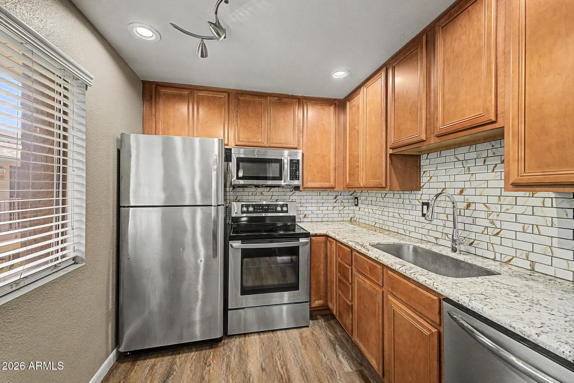 Discover effortless Scottsdale living in this beautifully updated one-bedroom, one-bathroom condo ideally situated within the community, just steps from the pool, fitness center, and convenient parking. Inside, the stylish kitchen showcases granite countertops and a designer tile backsplash, while new carpet and luxury vinyl flooring add a fresh, modern feel throughout. Whether you're looking for a full-time residence, seasonal retreat, or investment opportunity, this home offers comfort, convenience, and low-maintenance living. Located in the heart of Scottsdale, you'll enjoy easy access to Old Town Scottsdale's renowned dining, shopping, entertainment, resorts, parks, and golf courses.