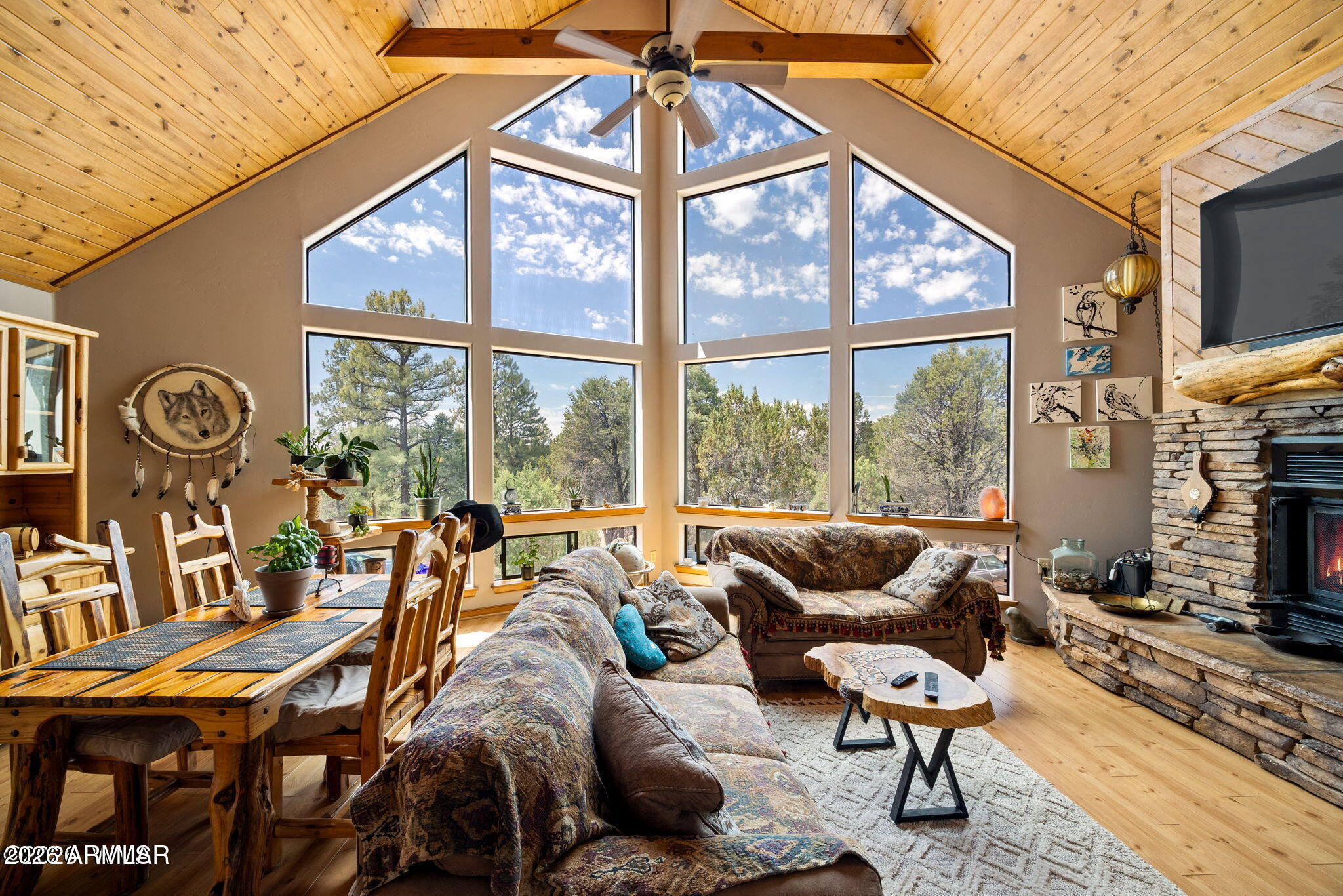 Custom-built chalet with amazing views! This beautifully appointed and freshly painted 3-bedroom, 2-bath home features a large, open great room with soaring ceilings, massive windows, and a stunning stacked-stone wood-burning fireplace. The open island kitchen offers stainless steel appliances, an undermount sink, custom hardwood countertops, and a one-of-a-kind stacked-stone backsplash. The primary suite includes hardwood floors, a spacious bath with deep double sinks, a walk-in closet, and a newly installed tub/shower combo with stacked-stone accents. The loft offers flexible space for a family game room, workout area, office, or extra sleeping quarters. Enjoy A/C, a covered deck, hardwood doors throughout inside of home. Plenty of room to park the big-boy toys and at Christmas time, imagine a tree soaring over 12 feet tall, making a statement in front of those breathtaking windows! Located in a well-established neighborhood. Worth taking a look at this beautiful home that can be used as a seasonal retreat or full-time home. Start making those memories!