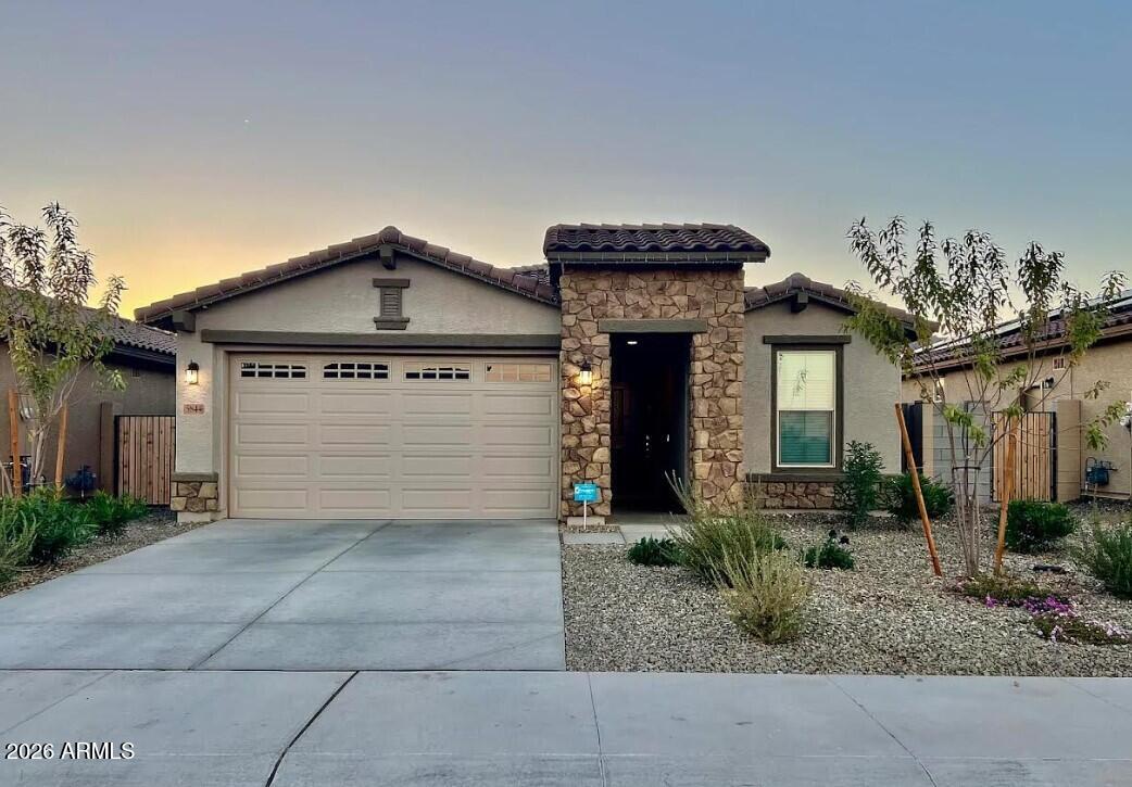 Park in front, mountain sunsets in back--this home delivers the best of both worlds!
Perfectly positioned with a large park right out front and a private backyard showcasing breathtaking west-facing views of the White Tank Mountains, this 3 bed, 2 bath home offers scenery and serenity in every direction.
Inside, you'll love the spacious kitchen featuring granite countertops, a large island with breakfast bar, walk-in pantry, and rich espresso cabinetry. Elegant ceramic flooring flows beautifully through the main living areas, adding warmth and style.
Step outside to the covered back patio and take in those incredible Arizona sunsets with no rear neighbors to block your view. The striking stone accent on the front elevation adds eye-catching curb appeal, while refrigerator, washer, and dryer are all included making this home truly move-in ready.

A rare combination of location, views, and thoughtful upgrades. Don't miss it!