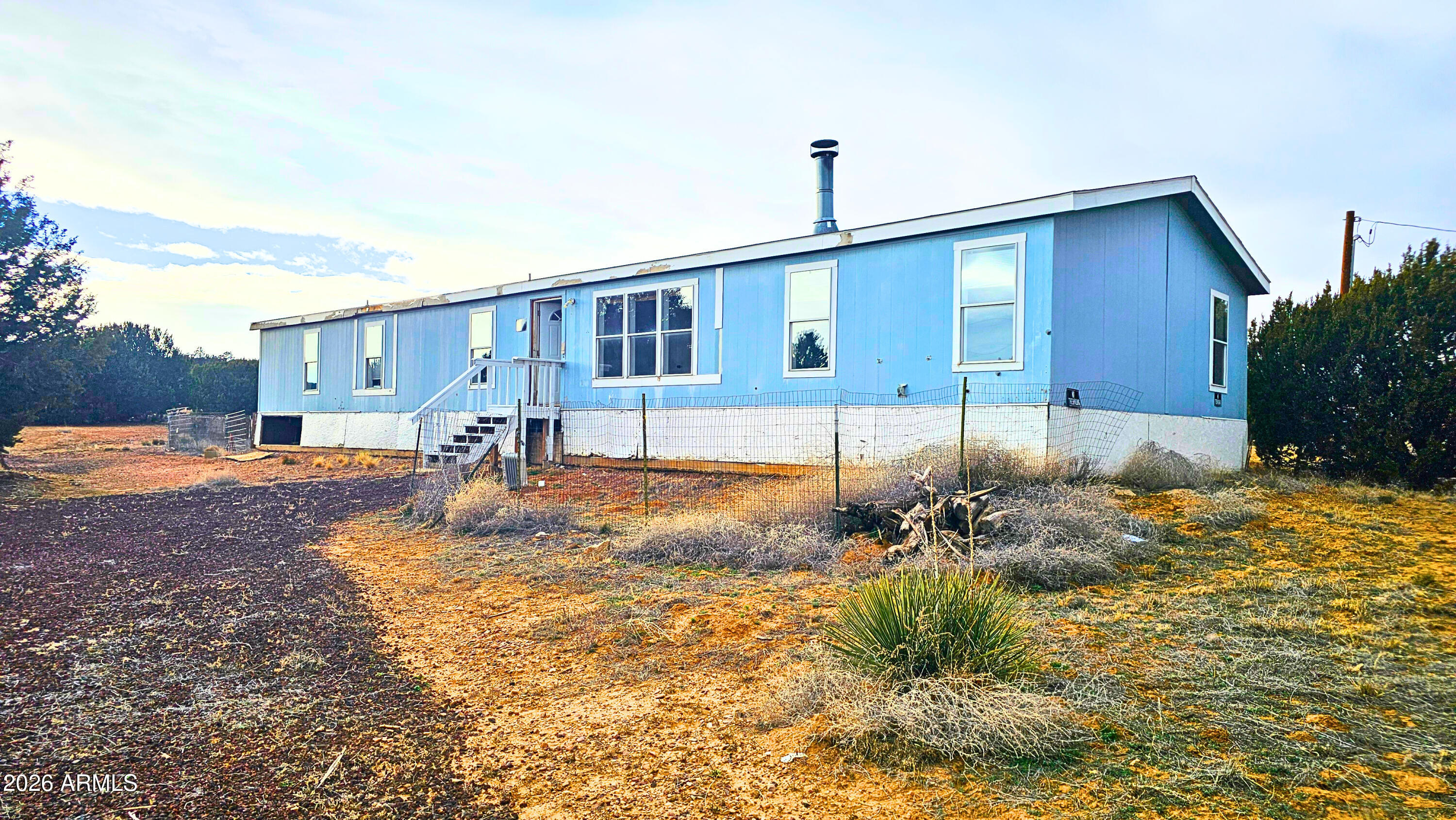 This spacious 4-bedroom, 3-bath, 2,052 sq ft home on 2.08 partially fenced acres is a perfect investment opportunity. Built in 2007 with one living room, one family room, and a den, it offers flexible space, mountain views, privacy plants, and essential utilities including water, power, and an owned propane tank. With quick access to Highway 61, it's a solid property ready for someone to bring new life to it. In the heart of Concho, AZ, this property offers the chance to shape a home that truly reflects your vision. With some cosmetic updates, it can become a standout retreat in the serene high-desert landscape. Concho is known for its peaceful living, open skies, and welcoming rural character ideal for anyone seeking room to breathe.

Just a short drive from the White Mountains, you'll enjoy access to lakes, forests, and year round outdoor recreation. This is an opportunity to create your dream home in one of Arizona's most scenic regions.