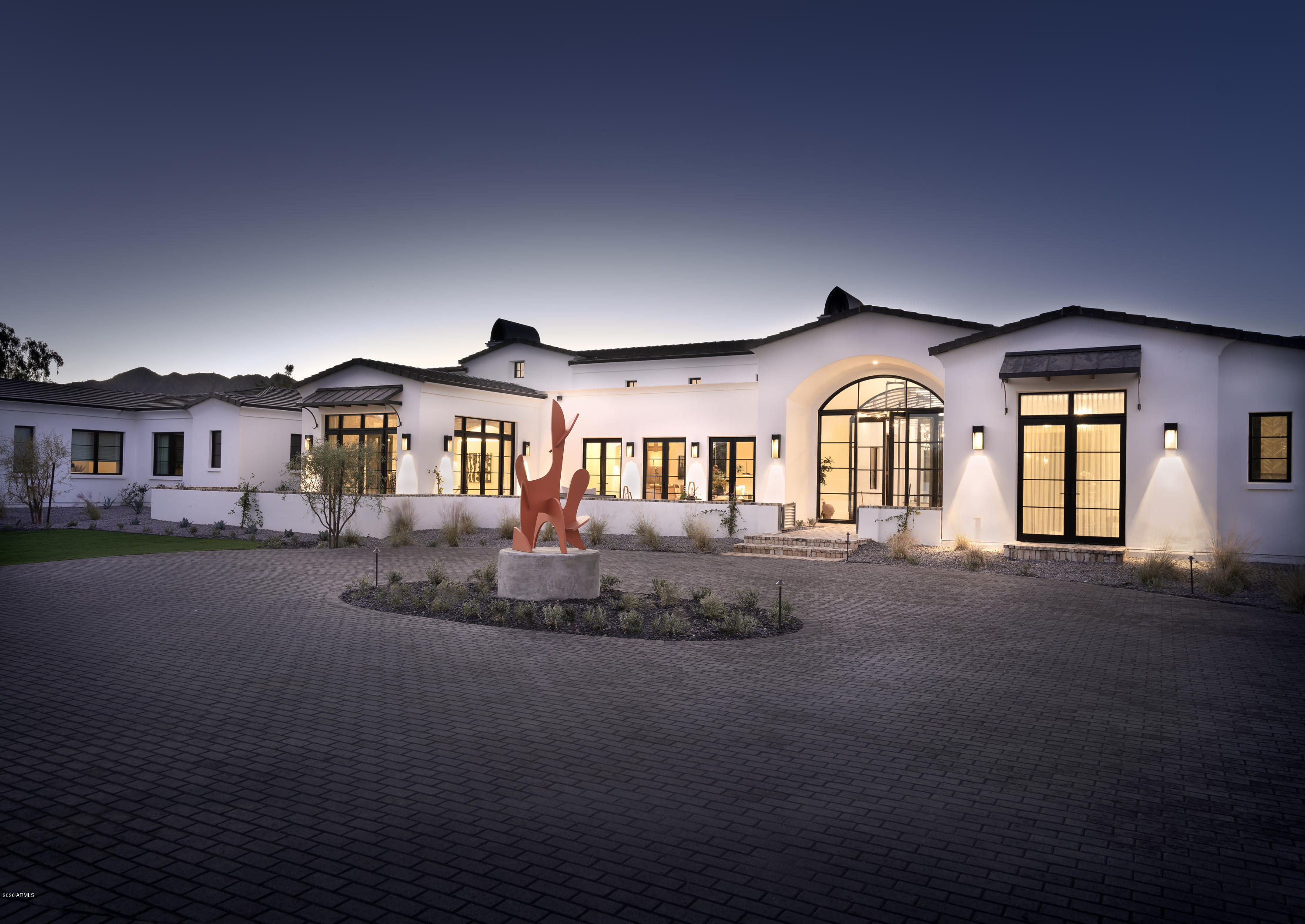 This custom showpiece has just been completed and is absolutely exquisite. The fresh modern vibe and incomparable design quality is the reason it's been selected as the 2020 Iconic Haus, which showcases the work of 20 of the most sought after and respected interior designers in the Valley—each added elevated interior elements and fixtures to every room. Every room is an individual creation and not a detail was overlooked. Each designer poured their heart and talent into their designated space in an effort to highlight the finest of what they are capable. As a luxury designer showhouse, national brands were quick to step up and offer the very latest technology in appliances, home automation and window coverings, along with elevated flooring, Italian tiles, custom wallpapers, handmade custom wall treatments and lighting selections. From the one in 110 limited-edition matte black/rose gold Viking Range to luxe lighting design and fixtures from Circa Lighting to high-design, never before-seen faucets and fixtures from Brizo, to the newest home teleconferencing solution from Crestron this home represents the best of the bestluxury at its finest.

This home was designed for today's families and their needs for the ultimate living experience in their homesmultiple office spaces for Zooming parents and kids (three in this estate) to a huge kitchen for families cooking at home more than ever to a full bar for enjoying a night out AT HOME. A dedicated man cave workshop provides an escape, adjoining a collector's garage with racing-stripped floors and automotive showroom lighting. 

The resort-style pool is a staycation in the making. When dinner with friends is in order, a butler's pantry, wine cellar and elegant dining room provide a stunning private dining experience for you and your pod. As the day winds down, the master retreat is a true escape with a marble fireplace, sitting area, spa-like master bathroom with double shower and Italian tile throughout.

The Master Builders at Temac Development entrusted Candelaria Design, the absolute best in architecture, ensuring a final product that is simple perfection. The home is also connected with Homekey intelligent technology, a highly impressive state-of-the-art system that details every element of the home with a maintenance schedule and warranty information. With unparalleled craftsmanship, endless amenities, and finishes that are as unique as they are timeless, this estate is for the sophisticated buyer who understands the value of quality and individuality. It's one of a kind and can never be duplicated!
