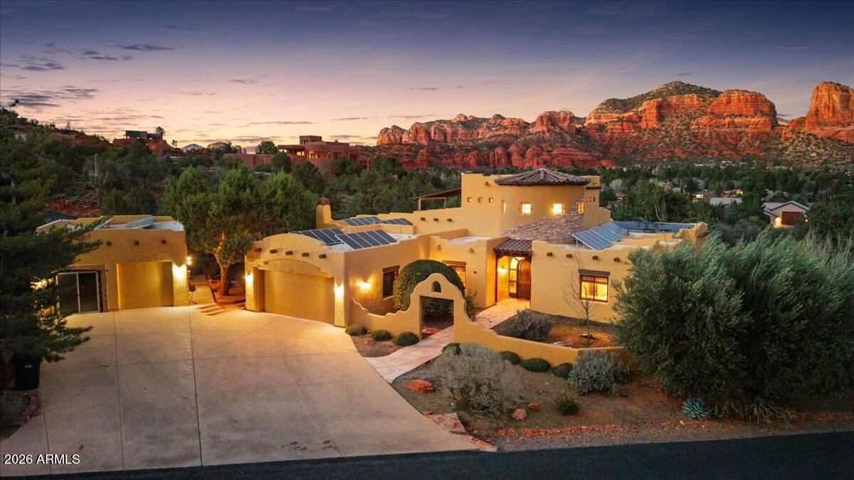 Unmatched panoramic views of Sedona's iconic red rocks set the stage for this stunning Southwest estate. Ideal as a luxury residence,guest retreat,or high-performing short-term rental, this property blends comfort,style,and investment potential. The main level features a bright open layout with a spacious living room and fireplace, formal dining room with its own fireplace, and a chef's kitchen with a large island, double ovens, and an oversized walk-in pantry. Downstairs offers a game/theater room, while a Spanish tile staircase leads to a versatile loft with incredible red rock views. Outdoor living shines with an outdoor kitchen, gazebo, putting green, fireplace, waterfall feature, and hot tub. A 700 sq ft detached garage can be turned into a casita or be reversed back to a garage!