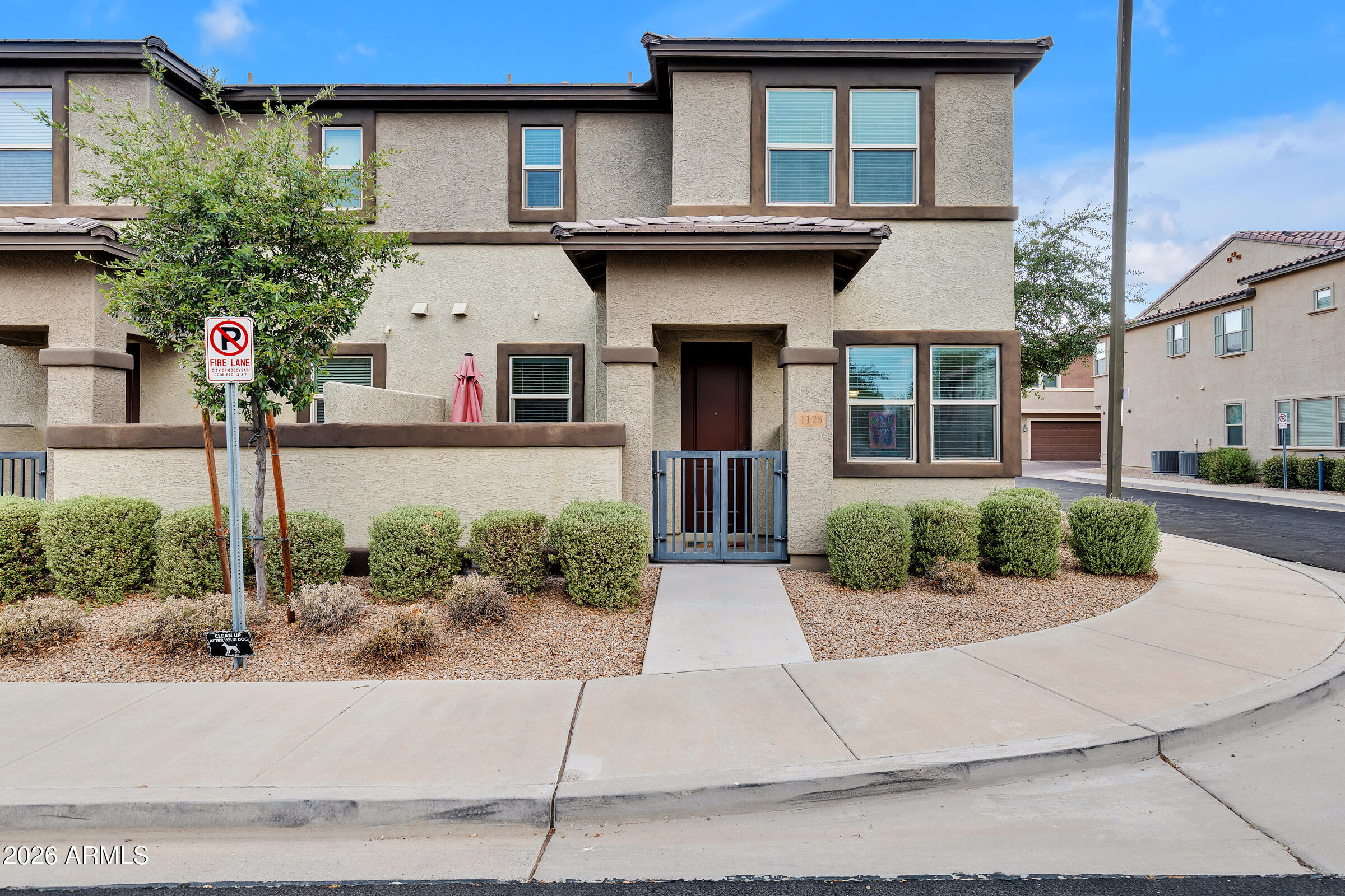 Welcome to the gated Village at Rio Paseo community in Goodyear, where this modern, low-maintenance townhome delivers move-in ready living. The bright, open floor plan features high ceilings, a gourmet kitchen with quartz countertops, an oversized island with seating space, stainless steel appliances, and a walk-in pantry. Upgrades throughout include tile flooring, recessed lighting, ceiling fans, and brushed nickel fixtures. Primary suite offers walk-in closets and dual-sinks. Enjoy resort-style community amenities including a sparkling pool, heated spa, fitness center, playground, and walking paths. - Temporary 1-0 BuyDown offered by preferred lender for qualified buyers. - You'll want to see this home today!