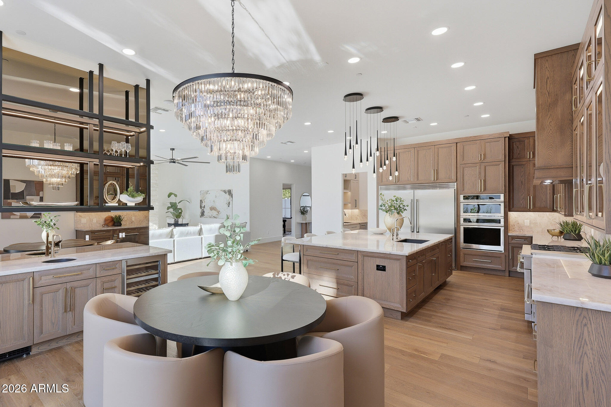 Introducing the one and ONLY first of it's kind newly constructed from the ground up custom residence in Scottsdale Ranch. A rare blend of refined first floor primary living, architectural warmth, and effortless everyday luxury. Thoughtfully designed for how people truly live, the home centers around expansive main-level living--where the primary suite and additional guest bedrooms create a seamless experience complemented by soaring ceilings and beautifully balanced proportions.
Inside, the home feels both tailored and timeless, with natural stone, Cristallo quartzite, and custom cabinetry layered alongside French white oak flooring. The result is a calm, elevated backdrop that feels thoughtfully curated rather than constructed. The kitchen anchors the living space as a design-forward centerpiece equal parts functional and sculptural ideal for entertaining, gathering, and daily life.

The first floor primary suite is a private retreat, featuring a spa-inspired wet room, soaking tub, and custom closets that evoke the feel of a boutique resort. Every secondary suite is equally intentional, with ensuite baths and walk-in closets offering comfort and privacy for family and guests.

Built as a fully integrated smart home, the residence delivers modern convenience seamlessly woven into the home's design. Outdoors, a professionally landscaped backyard unfolds as a private, resort-inspired extension of the home, featuring a heated pool, spa, and outdoor kitchen. The setting is ideal for relaxed living and entertaining within the privacy and prestige of Scottsdale Ranch. Minutes to the 101, dining, shopping, golf, lakes, and A+ Rated schools. All furnishings currently in the home convey. Absolute must see!
