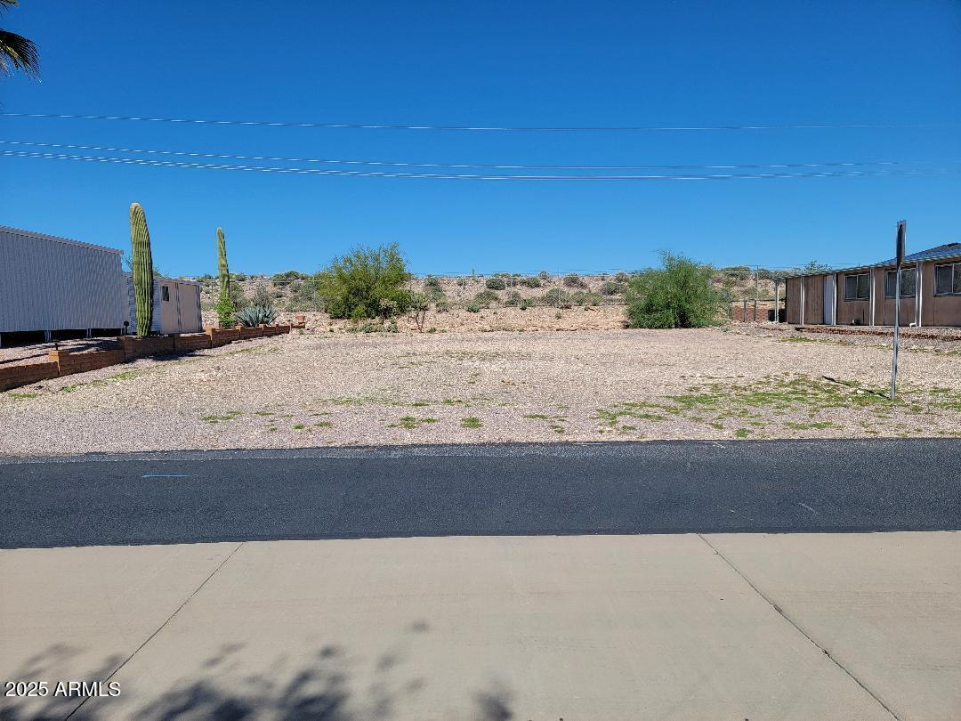 This property is a great level property at the top of the hill with views!! All utilities to the property line and ready for your dream home! You own the land here and low HOA fees! Enjoy all that Florence Gardens active 55+ community has to offer! Heated pools and spas, golf course, pickle ball court, billiards hall, craft rooms, library, work out room and more!