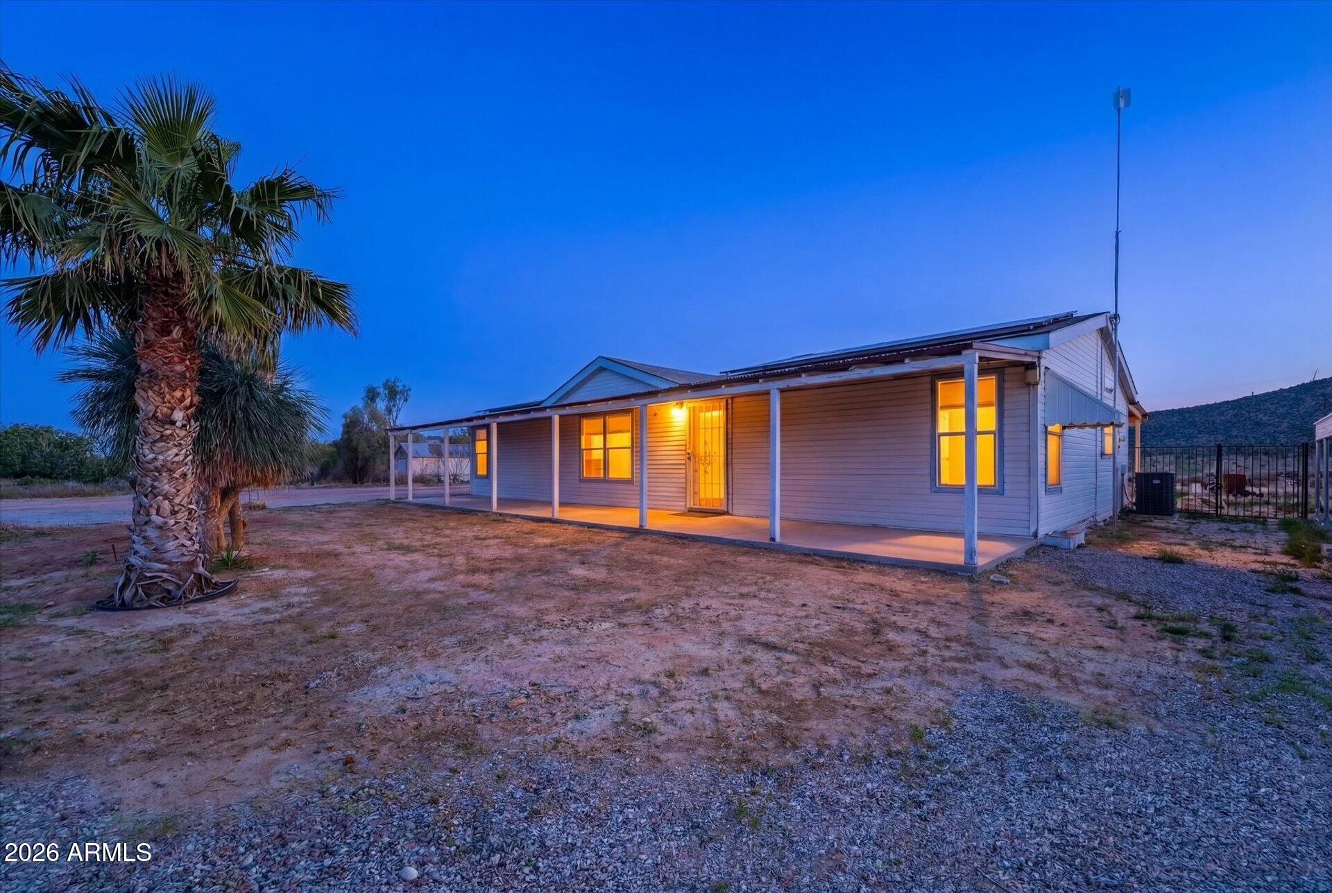 SELLER WILLING TO CONTRIBUTE TOWARD CLOSING COSTS and/or RATE BUY DOWN!! Enjoy wide-open Arizona living on more than 3 acres backed by protected mountain views. This 3-bedroom, 2-bath home features a private well, septic system, solar power, and space to create the lifestyle you've been looking for. Whether you're seeking a horse property, hobby farm, RV retreat, or simply room to spread out, this property offers flexibility and privacy rarely found at this price point. With breathtaking desert scenery, peaceful surroundings, and room for future improvements, this property delivers the perfect balance of country living and practical convenience.