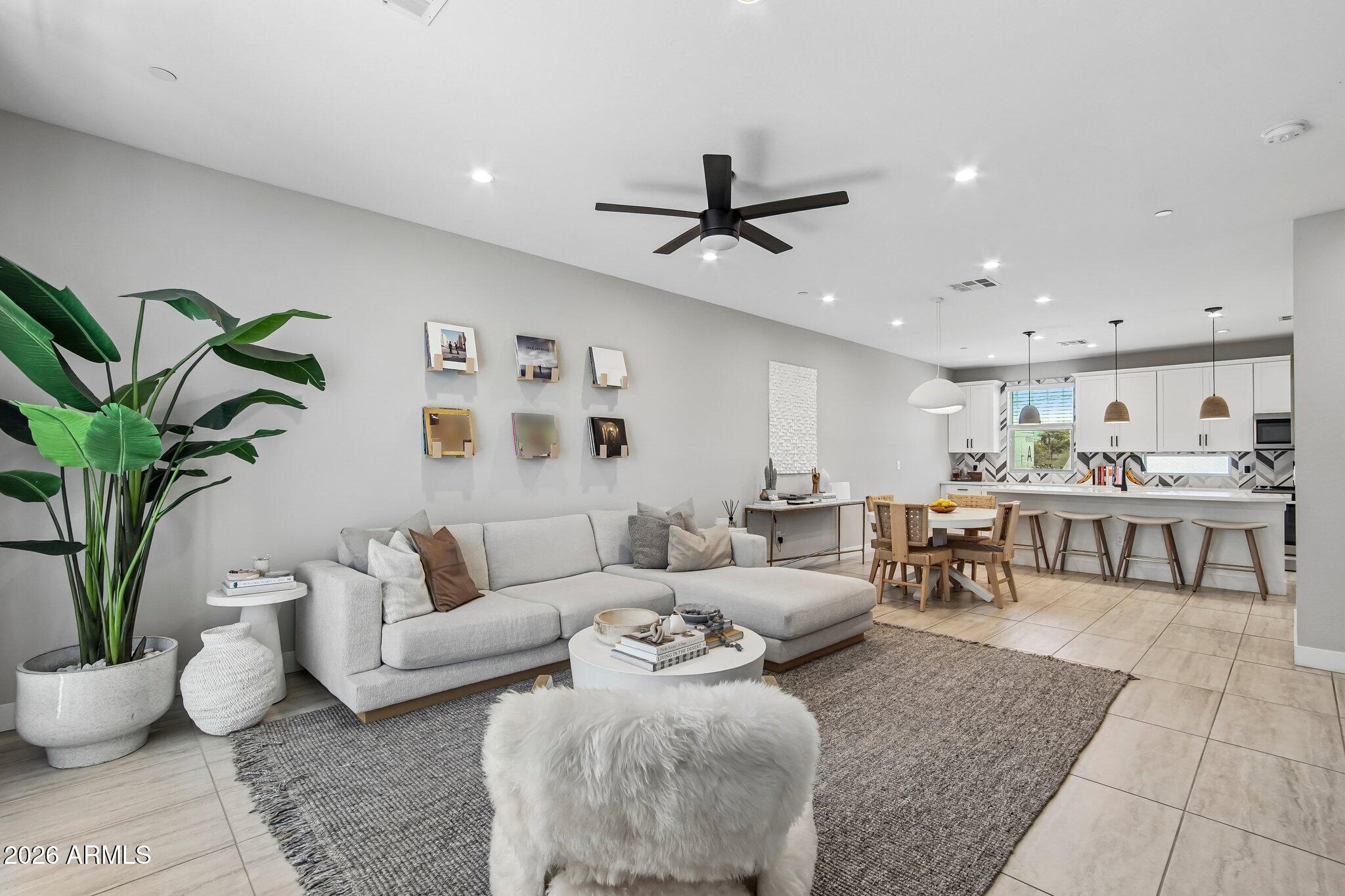 Rare opportunity to own a beautifully updated townhome in a gated community just minutes from Downtown Phoenix. Ideally located near Roosevelt Row's popular restaurants, coffee shops, art galleries, and entertainment, this home offers the perfect balance of urban convenience and neighborhood privacy. The thoughtfully designed floor plan features 3 bedrooms, 2.5 bathrooms, an attached 2-car garage, EV charger, and two additional driveway parking spaces. Downtown Phoenix skyline views can be enjoyed from the kitchen and primary bedroom, adding a unique urban backdrop to everyday living. The home also offers a private main-level patio and upper balcony for outdoor enjoyment. Inside, you'll find spacious living areas, oversized bedrooms, and a modern kitchen centered around a large island ideal for entertaining. Custom closet systems have been installed throughout, and two bedroom suites feature walk-in closets and private ensuite bathrooms. Recent exterior improvements include a new roof and fresh exterior paint completed within the last three months, providing added peace of mind for the next owner.
