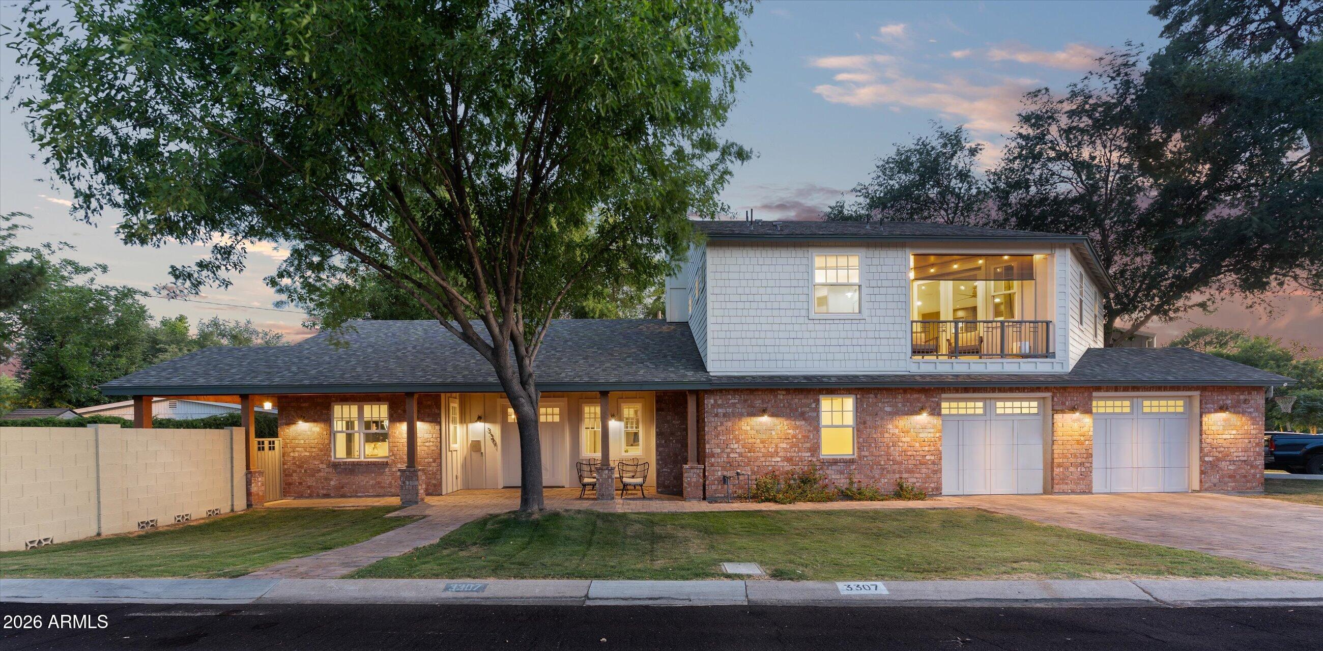 Located in the heart of Arcadia Lite, this beautifully designed home blends timeless style with modern comfort in one of Phoenix's most desirable neighborhoods. From the moment you enter, you are welcomed by soaring vaulted ceilings, dormer skylights, wide plank wood flooring, a custom brick fireplace, built-in bar, and downstairs hangout designed for both entertaining and everyday living. The chef's kitchen features KitchenAid stainless steel appliances, a gas range, custom cabinetry, Quartz countertops, and an open-concept layout that flows seamlessly into the dining and living spaces. The luxurious primary suite offers a private retreat complete with a sitting room, coffee bar, private balcony with Camelback Mountain views, expansive walk-in closet, and a spa-inspired bathroom.