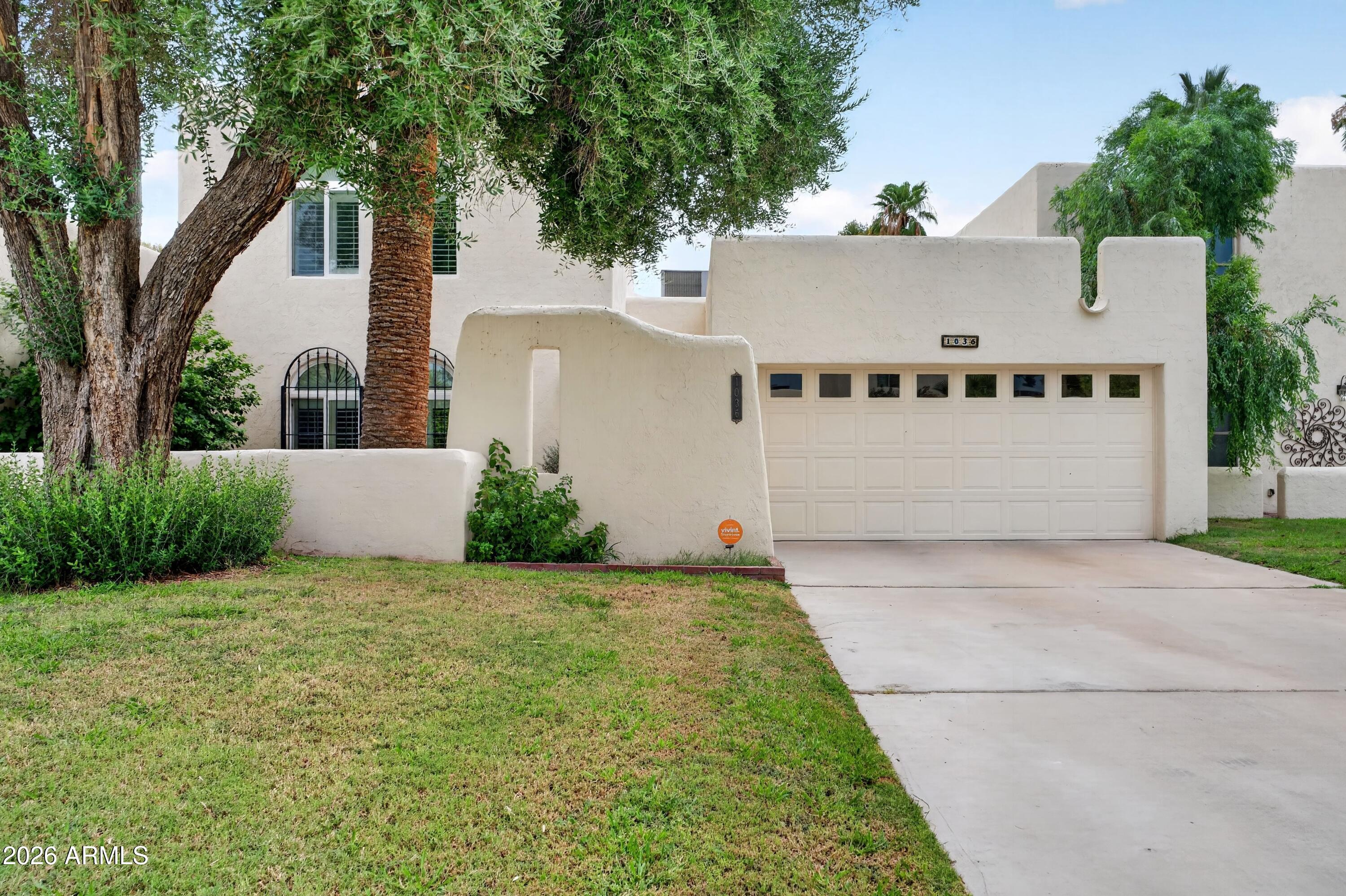 Beautifully maintained 3-bedroom, 2-bath home in the heart of desirable Litchfield Park, just minutes from the iconic Wigwam Resort, Litchfield Square, golf, dining, shopping, and parks. Inside, you'll find warm wood flooring, soaring beamed ceilings, and expansive Arcadia doors that fill the home with natural light and open to a private backyard with mature landscaping, flowers, herbs, and a citrus tree. The inviting living room features a fireplace and built-in bar, while the eat-in kitchen offers abundant cabinetry, generous counter space, and newer appliances. The spacious main-level primary suite is complemented by two upstairs bedrooms and a full bath, creating a functional and inviting floor plan.