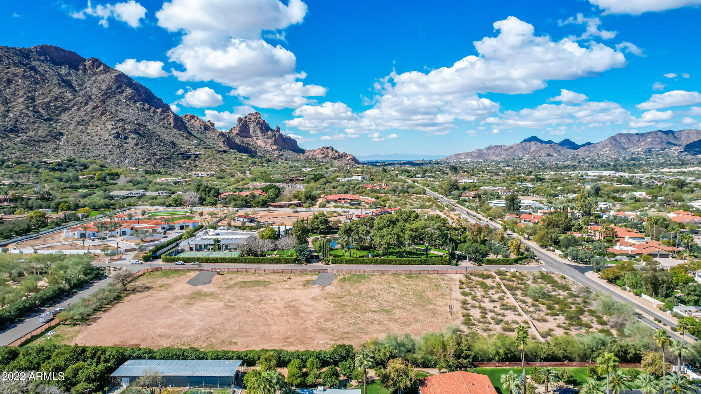 On the most prominent street of ''Billionaire's Row'', perfectly distanced from Camelback Mountain for superior views versus surrounding lots lies this over four acre parcel complete with two sets of plans. Ultimate privacy on a street of 30 million dollar homes. CP Drewett and Claire Ownby perfectly crafted a kid/ guest centric entertainers paradise. Modern mediterranean meets diligently curated architecture capturing 360 views. A few streets from iconic Sanctuary Resort, Mountain Shadows, the new Ritz Carlton amenities and valley's best golf and restaurants. The sellers have saved a buyer years of planning. Own the best remaining parcel in PV.