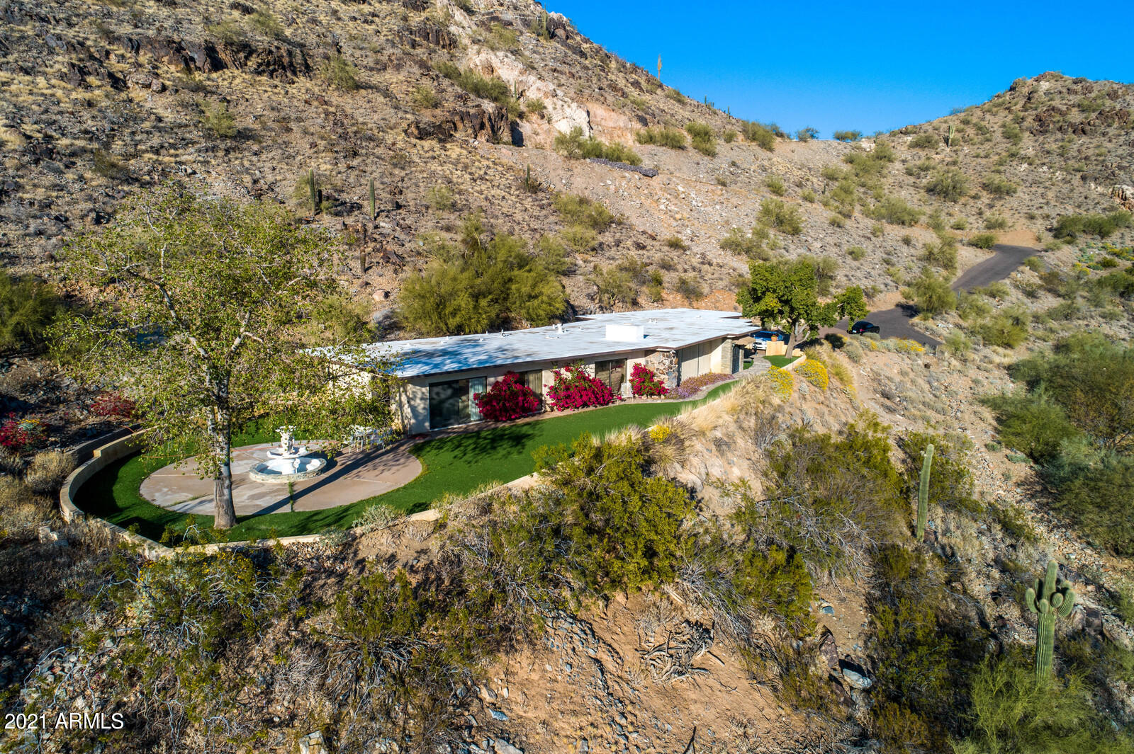 WOW!!!  Hillside property in Paradise Valley.  South side of Mummy Mountain on almost 4 acres.  Spectacular views including downtown Phoenix, Camelback mountain, Scottsdale and so much more.  Many opportunities with this property.  Rehab the existing property or build your dream home.  Very private and an incredible opportunity.