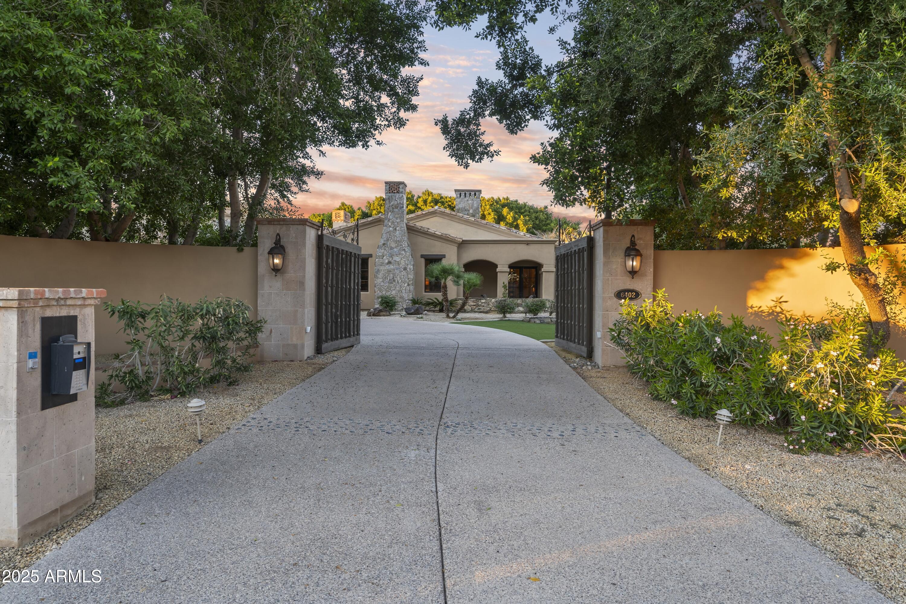 Completely walled and electronically gated with security surveillance cameras on 2.26-acres of lavish grounds adjacent to Phoenician Resort. Perfectly nestled in the heart of Paradise Valley, this Mediterranean Architecture estate was meticulously built and landscaped with the ability to expand to its seven-car air-conditioned garage. Room to add an RV Garage, Tennis/pickleball or other sports courts here. The grand residence boasts six luxurious bedrooms, 7 bathrooms plus 2 powder baths, soaring ceilings adorned with detailed craftsmanship and private patios for each... The split floor plan allows the primary to remain private, it features a spacious sitting room, dual spa-inspired baths, and furniture-grade walk-in closet cabinetry. Central to the home is a gourmet ... See Motion Video kitchen designed for exquisite entertaining, seamlessly flowing into a grand family room and an elegant wet bar, adjacent to a sophisticated dining room and walk-in wine cellar. The home offers a theater, game/billiards room, exercise room, library, and study. Mature landscaping throughout, features covered patios, a Ramada, a fireplace, a heated pool, plus a jacuzzi; perfect for relaxation or grand events. A well-appointed 1,401 sq ft guest home complete with full kitchen adds to the estate's luxury, making this home a pinnacle of secluded elegance and an ideal setting for those who value privacy and exclusivity.