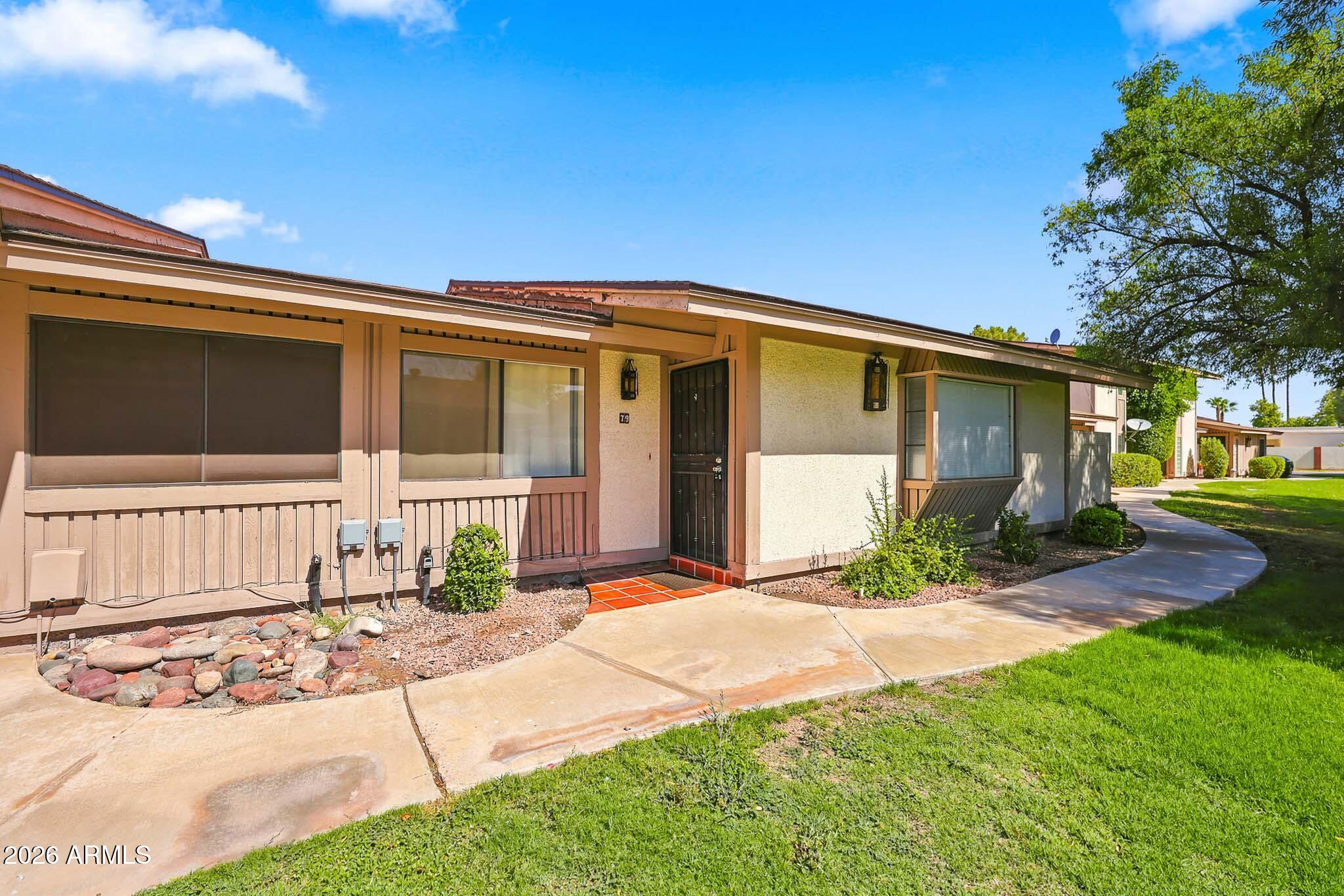 Beautifully maintained property in a highly sought-after North Mesa townhome community! The kitchen offers oak cabinetry, newer countertops, black appliances, built-in microwave, and refrigerator included.  Wood flooring in main living and carpet in bedrooms.  Spacious primary suite with walk-in closet. Major updates include A/C replaced in 2017 and water heater in 2016. Attached 2-car carport plus TWO storage sheds provide excellent storage. Enjoy the private courtyard with tiled flooring, pergola, and lush plants. Screen doors, washer, dryer, and fridge all convey! Resort-style community amenities include clubhouse, pool, basketball court, playground, mature trees, and greenbelts. Prime location near the 202, 101, Tempe, Scottsdale, and ASU!