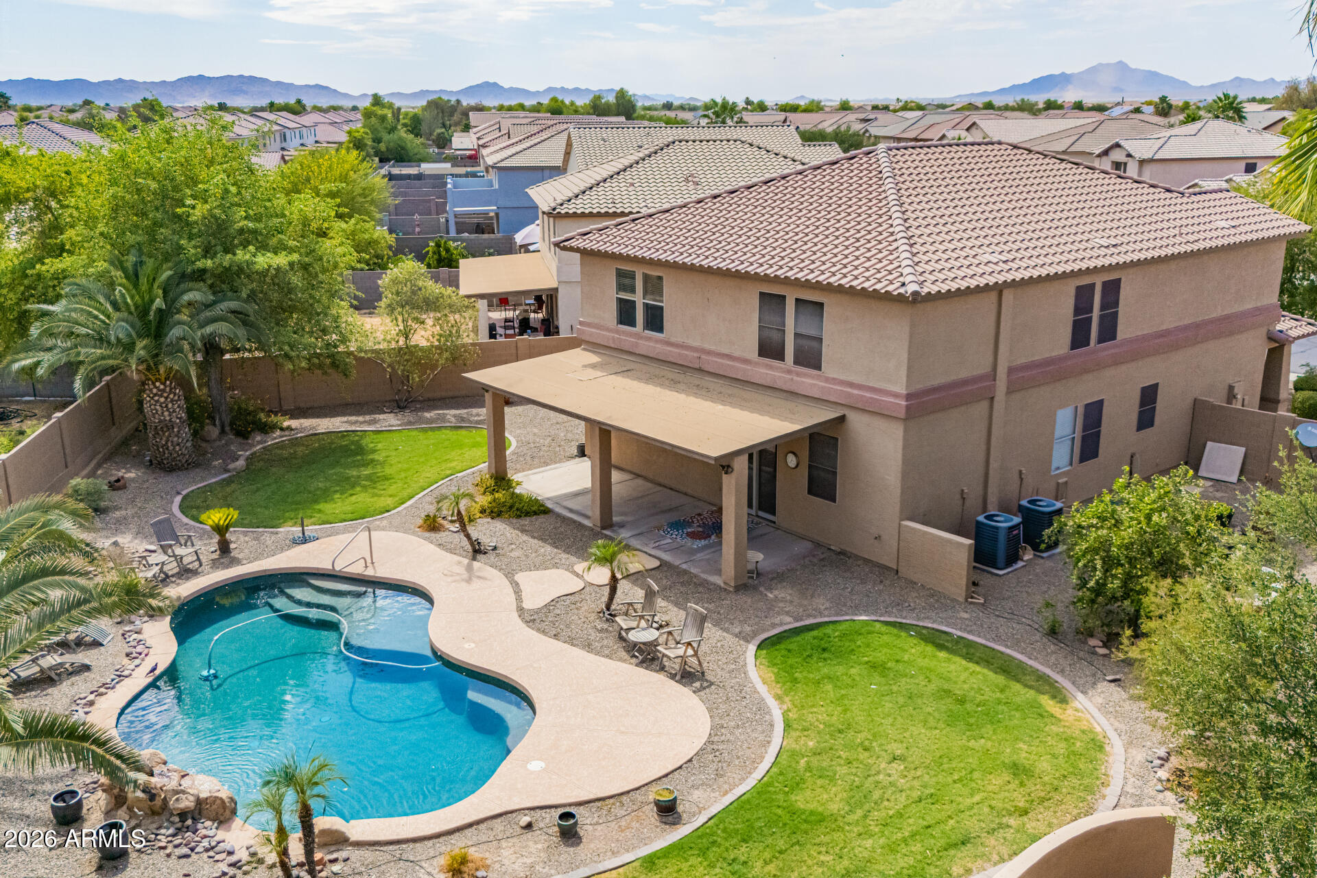This 2 story POOL home on a massive pie-shaped lot features the primary bedroom downstairs! The house has new interitor paint and carpet throughout. The kitchen tile floor, maple cabients, granite countertops, a custom extended breakfast bar with built in beverage cooler and stainless steel appliances- including the fridge. The primary suite offers a spacious retreat with dual vanity, soaking tub and walk-in closet. The living room has custom cabinetry with shelves and 18'' diagonal tile floors and upgraded sliding door overlooking the resort-style backyard oasis designed for the ultimate outdoor lifestyle. The property features a sparkling pool with rock waterfall, lush trees, garden beds and manicured green lawn areas. Uptairs has a giant loft with antique chandelier - perfect for a pool table. Huge laundry room has ample space for sorting and includes washer & dryer. The three bedrooms are oversized and all have walk-in closets. There is a whole house water softener in the two car gargage which also has professionally hung storage racks. The Meadows neighborhood has walking paths, mature landscape, playgrounds, frisbee disk golf course and is located near several schools.