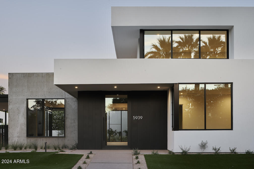 Incredible opportunity for a recently built Ben Hawkins home perfectly located on the highly desired Orange Blossom Lane adjacent to Arizona Country Club. This captivating cutting edge contemporary exudes style & class that few homes can match. Soaring tongue in groove detailed ceilings pull you into extraordinary inside/outside living that combines the custom island kitchen, living room, resort pool & outdoor dining. Stunning primary retreat provides views & privacy. 3 thoughtfully designed en suite bedrooms  provide comfort for all. Upstairs flex space for office/art studio/workout or music room leads to a spacious outdoor deck. Ease of access with street access out both the front & back. Artistically blended concrete & wood design elements impresses the most discerning of tastes.