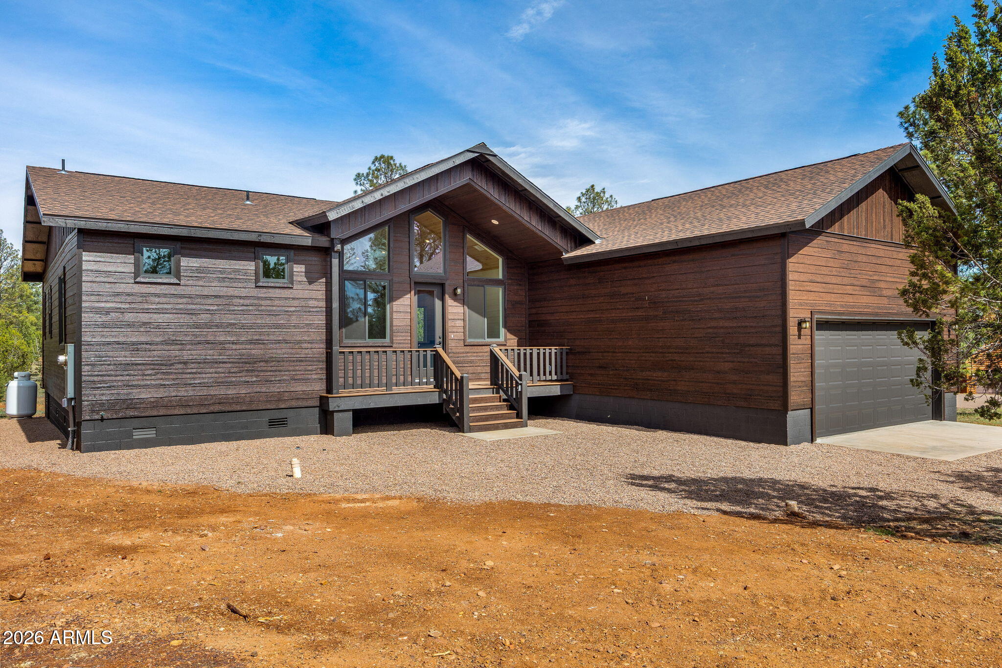 New Construction all electric 3 BR/2 BA cabin nestled on 0.81 acres in the Mogollon Estates in the Rim Community of Overgaard. The cabin will feature a great room design with T&G ceiling and fireplace, a large kitchen with an island and granite countertops, ceiling fans, central heat and air conditioning, a laundry/mud room, a generous master bedroom with an en-suite master bathroom, and generous size guest bedrooms. The exterior will boast covered decks, smart siding and a two-car garage. This lot very nicely treed on a cul-de-sac corner lot in a coveted area of Overgaard with easy access to the Forest. The photos are an exact duplicate except will have a fireplace and T&G ceiling in the great room.