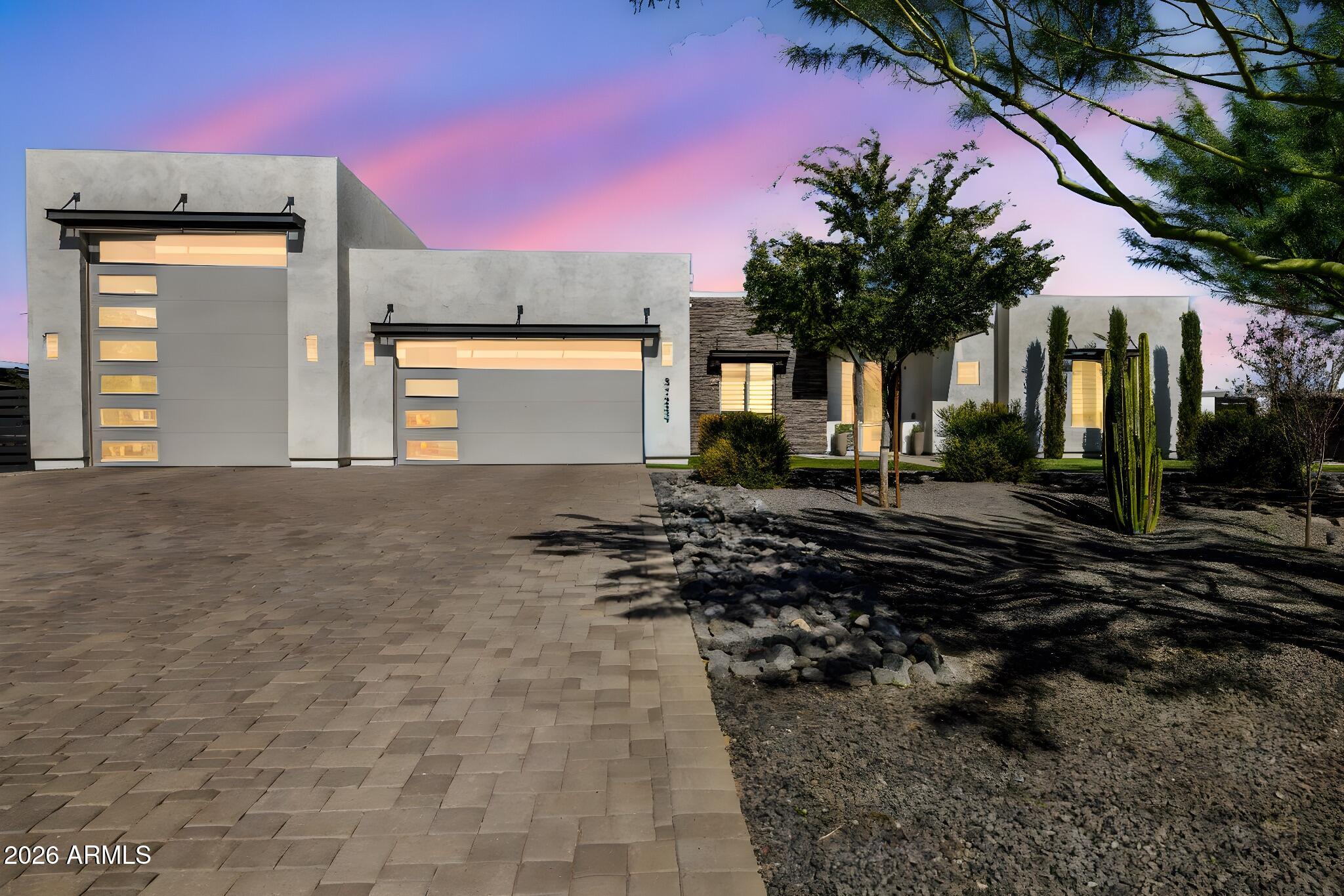 Stunning contemporary home on over an acre in desirable North Phoenix with no HOA. This highly upgraded 2020 home offers 4 bedrooms, 3.5 baths, a dedicated den/office, and a split floor plan with a Jack-and-Jill bath. Features include a custom fireplace media wall, designer kitchen, waterfall island, quartz countertops, upgraded appliances, built-in oversized refrigerator/freezer, and designer finishes throughout. Enjoy over 250k in upgrades, professionally finished landscaping, 5000+ sqft of pavers and travertine, and outdoor kitchen with pergola, dual Rv gates with drive-around access, pull-through RV garage, RV hookups, insulated RV garage and epoxy garage floors. Combining modern design and exceptional functionality, with room for a future pool, guest casita or other outdoor amenities.