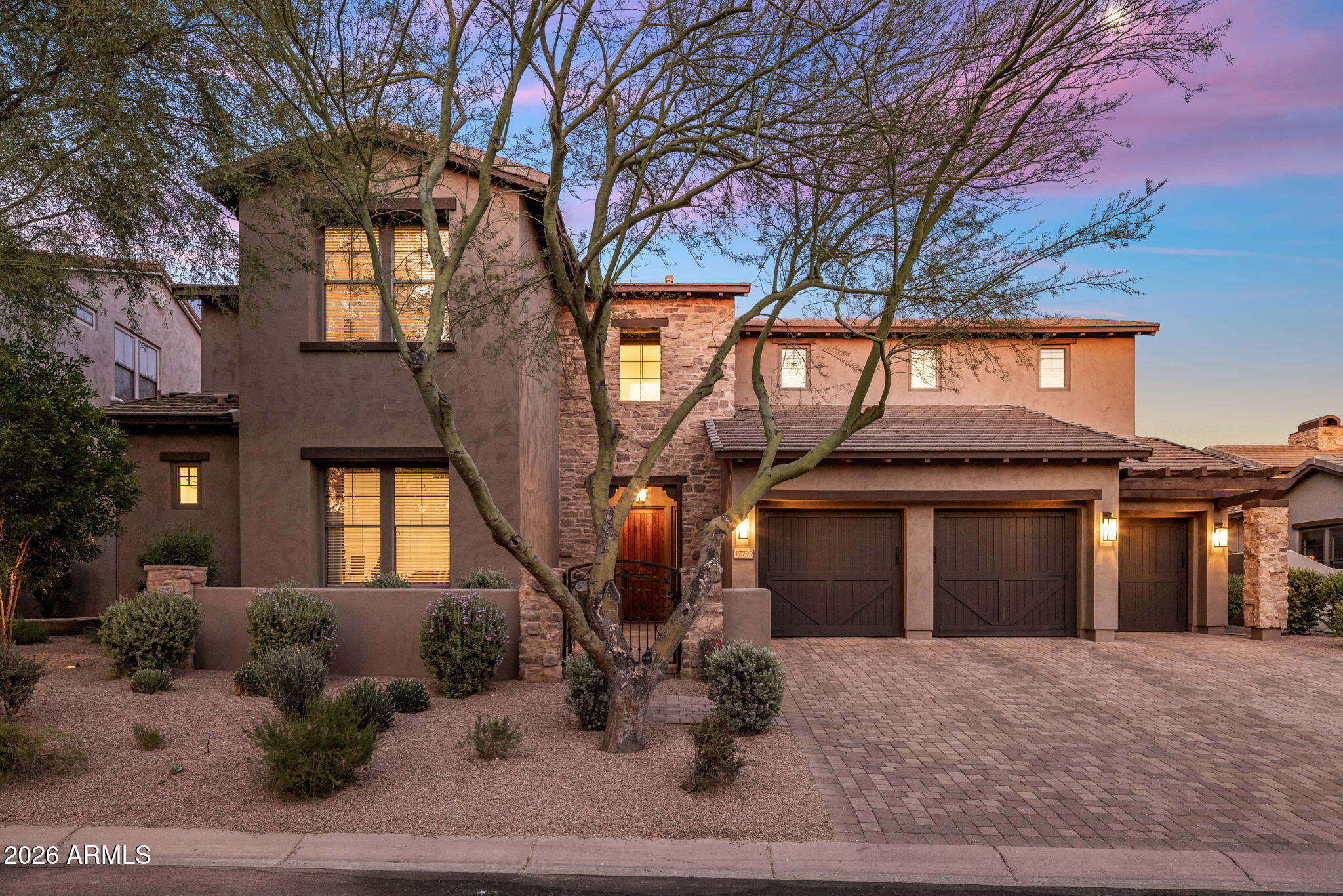 Experience elevated desert living in this beautifully updated two-story residence located within the gated Desert Haciendas community of DC Ranch. Perfectly positioned on a coveted wash lot, this exceptional home captures unobstructed views of the McDowell Mountains while offering refined indoor-outdoor living in one of North Scottsdale's most sought-after neighborhoods. Designed with clean lines, soaring ceilings, and an open-concept floor plan, the home seamlessly blends sophistication and comfort. The main level features four bedrooms plus a private den, while the upper level offers two additional bedrooms and an expansive game room, providing flexible living spaces ideal for family and guests. Extensive interior updates throughout include wood flooring, upgraded baseboards, renovated kitchen and bathrooms, custom window coverings, designer lighting, and a striking custom wine wall with glass doors that serves as a sophisticated focal point. The chef's kitchen is appointed with Quartzite countertops and backsplash, custom hardware, Viking stainless steel appliances, a large island with seating, generous casual dining area, and a dedicated beverage bar area. The adjacent family room is both warm and inviting, highlighted by tall ceilings, a fireplace, and expansive views overlooking the resort-style backyard. The luxurious primary suite is a true retreat, featuring serene backyard views, a coved ceiling, custom closet, and a beautifully upgraded spa-inspired bath with marble counters, separate soaking tub and shower. Outdoor living is equally impressive. The backyard showcases a travertine stone patio, sparkling pool with water and fire features,  spa with spillover, separate fire pit, and a spacious covered patio designed for year-round enjoyment. A private side courtyard off the kitchen includes a built-in BBQ and smoker.  The home is located just steps away from Desert Haciendas' grassy neighborhood park and playground.  In addition, DC Ranch residents enjoy access to an exceptional lifestyle with 2 community centers including the Desert Camp Community Center, which offers a lap pool, toddler pool, fitness facility, tennis and pickleball courts, playground and a sport court.  DC Ranch maintains over 50 miles of landscaped paths and trails and is located within minutes to the hiking trails of the McDowell Sonoran Preserve and Gateway Trailhead.  The community is also conveniently located close to an abundance of shopping and dining venues, golf courses, healthcare campuses, and the 101 Freeway.