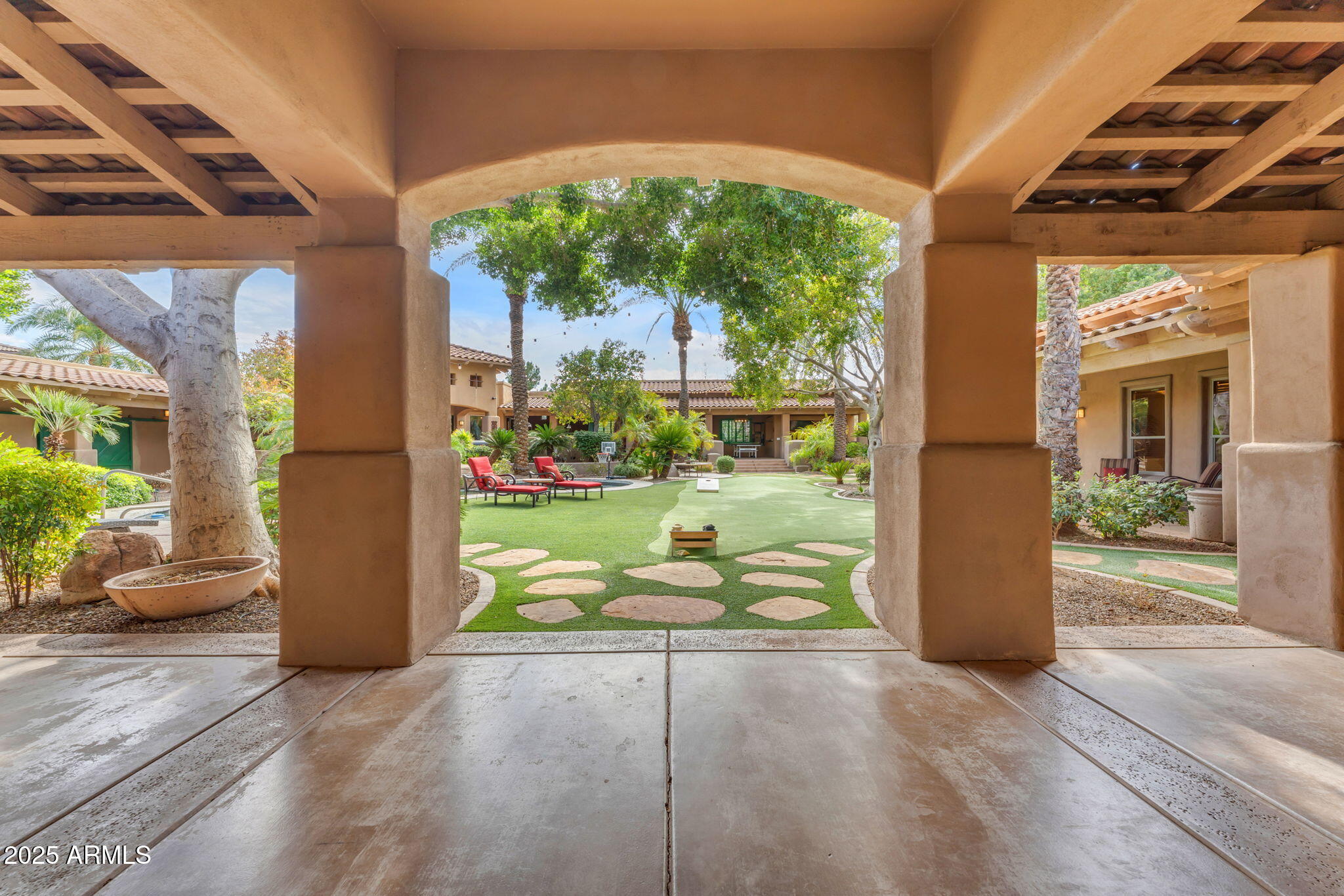 Experience resort-style living on just over an acre in this nearly 7,000 sq. ft. estate featuring 7 bedrooms, 7 bathrooms, and a private guest house—all with NO HOA! Generated $494k in gross rental income in first year as a rental! Neighboring property 11593 E Cochise sold at 5.95m with similar layout but interior lot last March! The chef's kitchen is a culinary dream with high-end stainless steel appliances, double wall ovens, and abundant cabinet space. Unwind in the private sauna or entertain with a heated pool, hot tub, putting green, built-in BBQ, and outdoor fireplace, all surrounded by lush landscaping. Enjoy a classic movie in the home theater! Furniture and furnishings are included, making this exquisite retreat truly move-in ready!