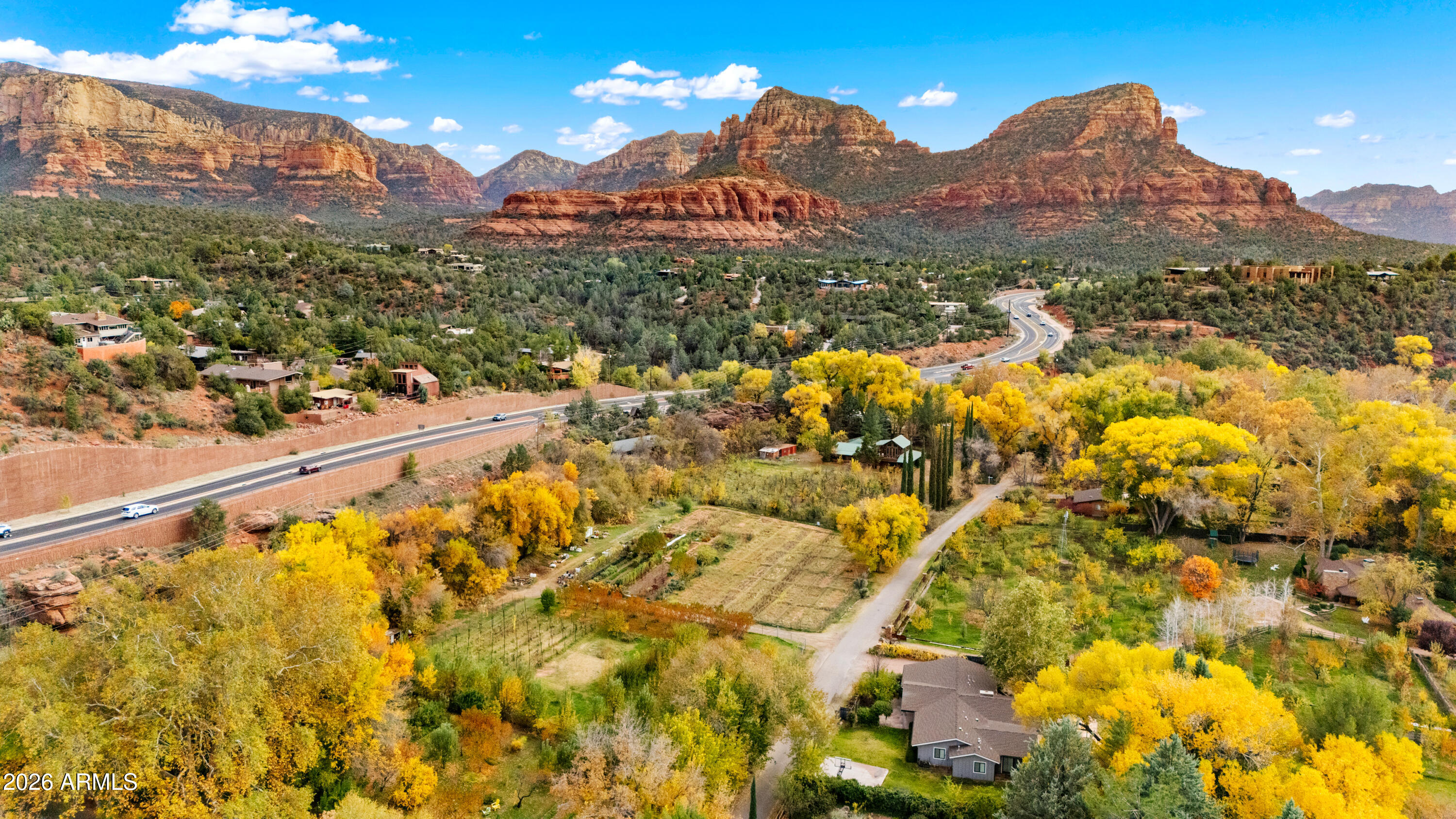 Step into a Sedona lifestyle where serenity meets possibility. Set on 2.32 picturesque acres along scenic Highway 179, this exceptional property offers far more than a home, it's a unique destination.  The 2,915 SF main residence features 3 bedrooms, 2 baths, thoughtfully positioned to capture the beauty of its surroundings. Beyond the home, a thriving 300-tree apple orchard creates a truly special setting, complemented by an operational business license for Oak Creek Apple, LLC. w/ space for up to 17 parking spots, the groundwork is already in place for a charming farm-like stand or boutique agricultural venture or family compound w/ room for expansion.  Just below the cider stand, sets a 1,451 SF guest house, once a beloved country store. Bring your creativity to this rare land! This is more than a property, it's a lifestyle opportunity. Embrace farm-to-table living, soak in breathtaking red rock views, and enjoy the convenience of nearby town amenities just minutes away from Tlaquepaque Arts & Shopping Village and directly across from Hillside entertainment hub. Live, work, and create in harmony, all in one extraordinary setting.