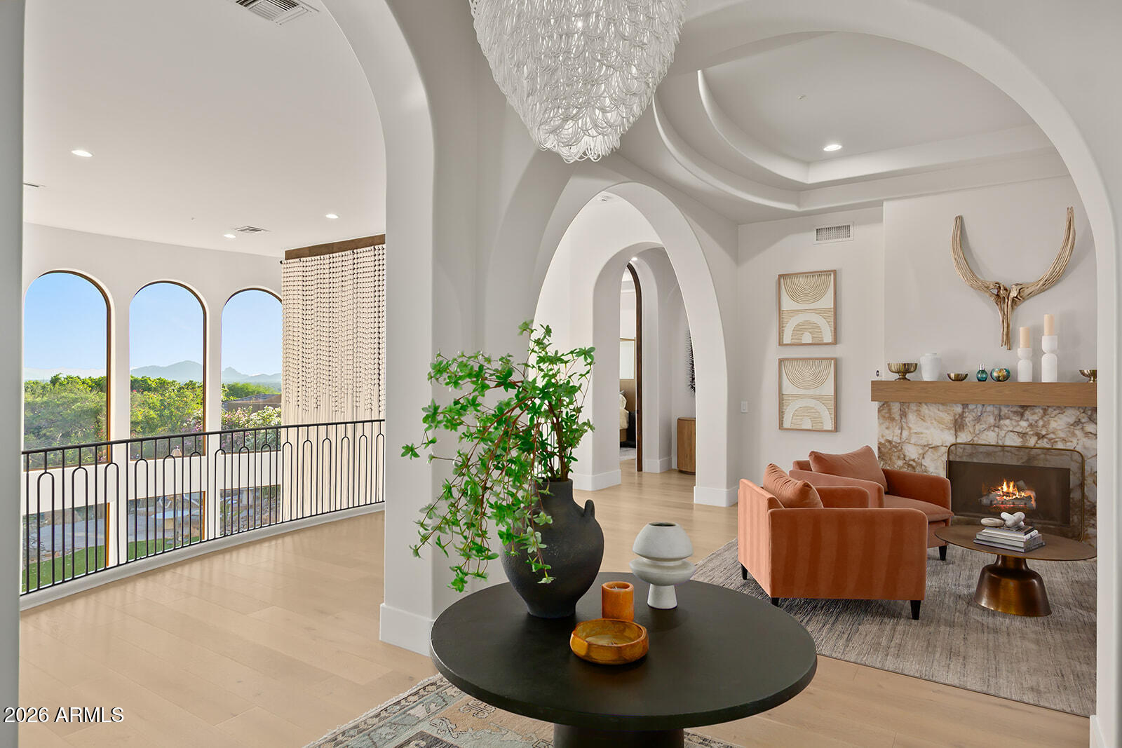 Panoramic views of city lights and Camelback Mountain define this magnificent, guard-gated Ancala hillside estate, completely reimagined by a comprehensive modern renovation. A newly optimized layout highlights premium new flooring, sleek finishes, and a state-of-the-art chef's kitchen. Massive windows bathe the space in natural light, leading to a master sanctuary, 4 generous ensuite bedrooms, and a huge bonus/theater room.
The south-facing backyard features brand-new synthetic turf framing an infinity pool and spa. Residents can join the prestigious Ancala Country Club, offering an 18-hole Perry Dye championship golf course, tennis, fitness, and upscale dining. Features rare dual-street access, a gated 10-car motor court, and a 3-car garage.