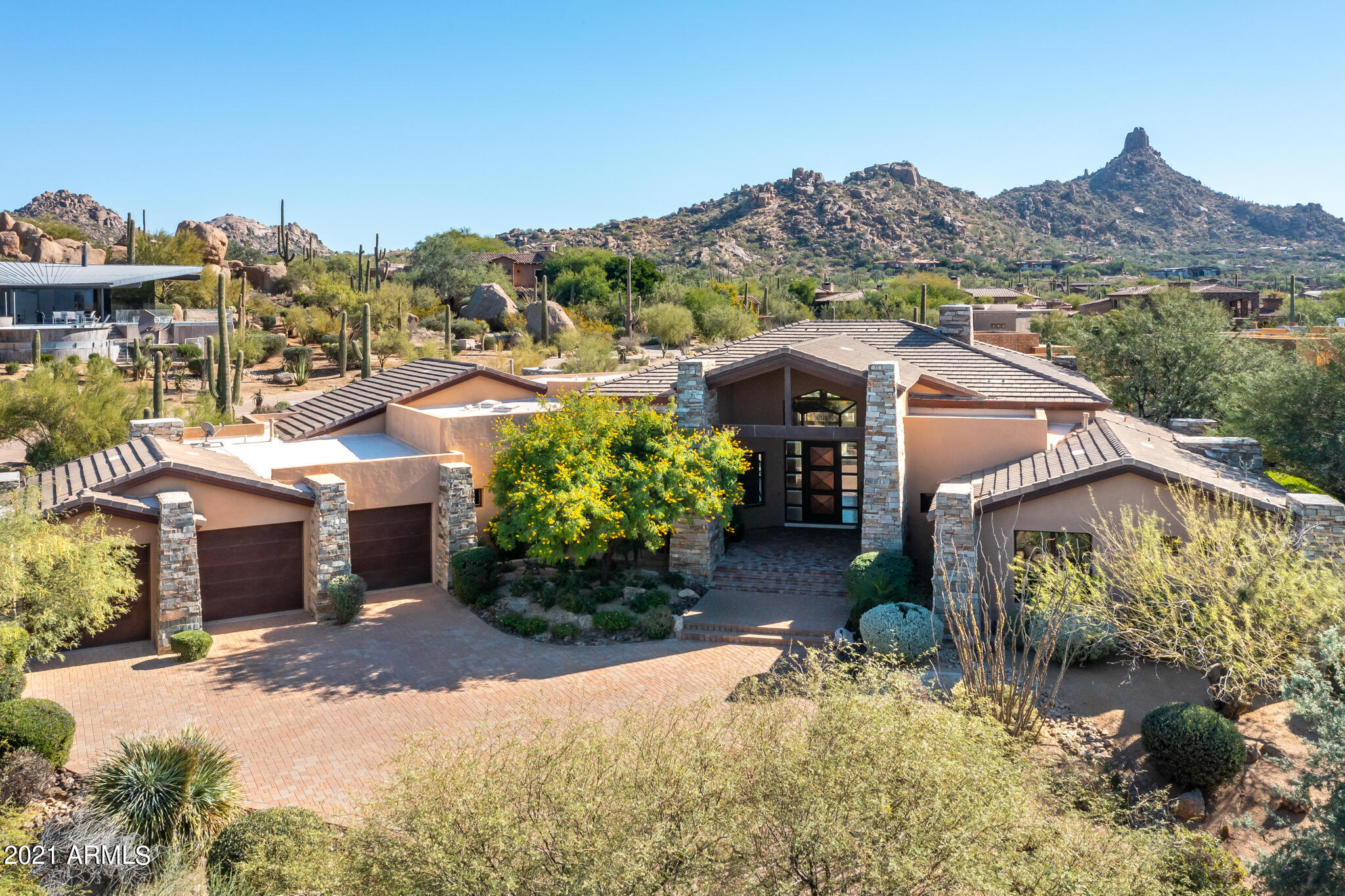 Warm Contemporary Custom Home, meticulously appointed * Oversized windows fill this home with light and fantastic views of Pinnacle Peak * Great attention to detail is reflected throughout this Great Room plan with extensive woodwork, Wet Bar, wine chiller, custom lighting, Built-in display cabinets, and extensive storage. * Private patios, spa & pool, outdoor dining * A large master retreat features a sitting area, built-ins, gas fireplace, his/her walk-in closets, stacked washer/dryer, steam shower, exercise area, 36'' high basin counters, and jetted tub * Two guest suites each have walk-in closets, full baths, and sliding doors to private patio *