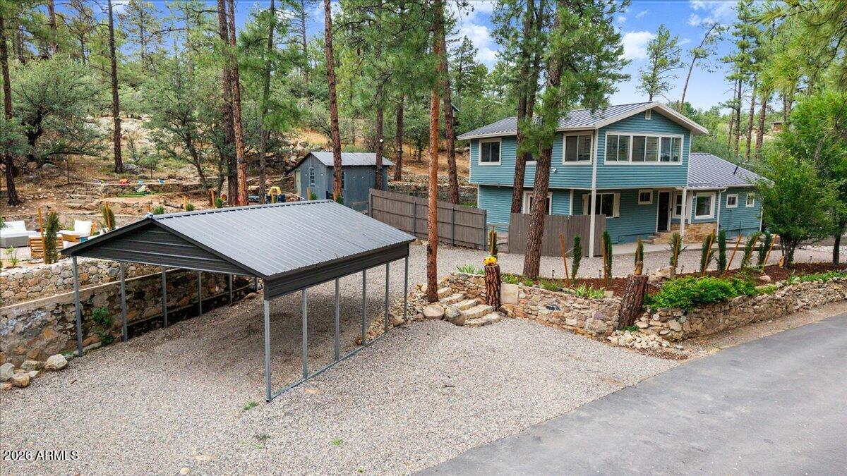 Welcome to this beautifully updated home in the highly sought-after Hassayampa Mountain Club, perfectly situated on a rare double lot offering exceptional privacy, usable outdoor space, and a true mountain retreat feel. Surrounded by towering pines and just a short drive from historic downtown Prescott and Whiskey Row, this property combines peaceful living with unbeatable convenience. The recently remodeled interior features luxury vinyl plank flooring throughout, a stunning updated kitchen, and beautifully renovated bathrooms. The spacious main-level primary suite provides comfort and convenience, complemented by a laundry room, dining room, storage and an additional half bath on the main floor. Upstairs, you'll find two generously sized bedrooms, a large office that is ideal for working from home or a flex space, and an additional full bathroom. Outside, the front and backyard offer endless opportunities for entertaining, gardening, or simply enjoying the serene surroundings. Relax on the charming pocket patios tucked throughout the property, enjoy the convenience of a pass-through driveway, a two-car carport, and the durability of a metal roof, Newer AC Unit installed in 2025. With paved access all the way to the property, abundant outdoor living space, and a setting that captures the beauty of Prescott, this is a rare opportunity to own a special home in one of the area's most desirable neighborhoods.