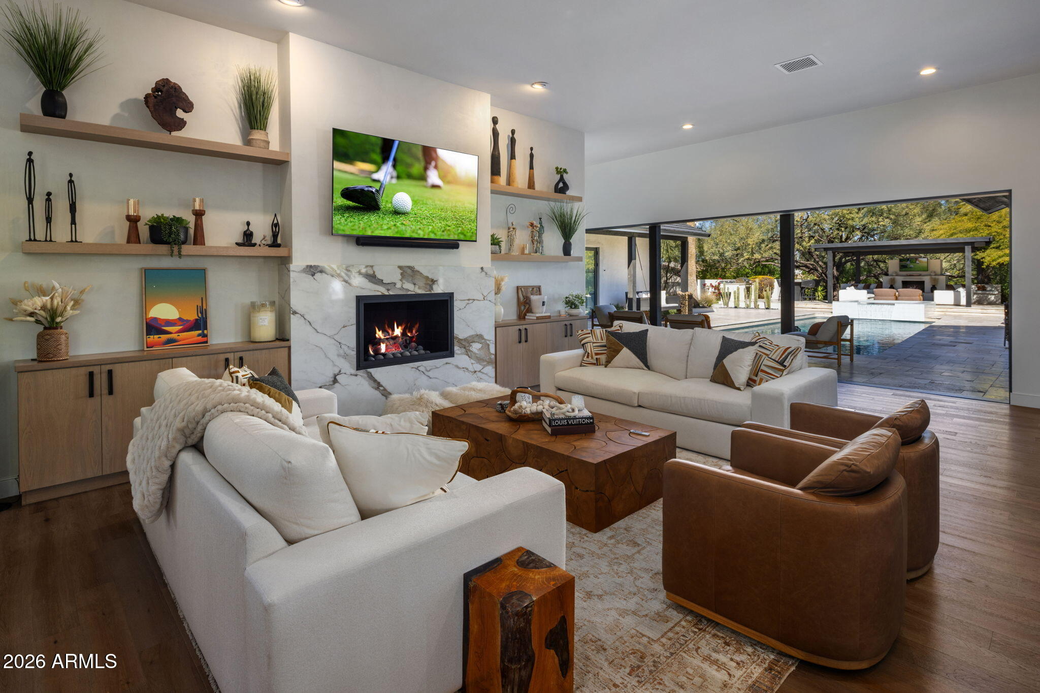 Stunning modern transitional estate on over an acre in one of Paradise Valley's most sought-after neighborhoods. Recently remodeled with exceptional attention to style and comfort, this 5-bedroom, 5.5-bath residence features soaring 12-foot ceilings, a dedicated large flex room, spacious den, and an open-concept kitchen and great room with a custom indoor outdoor bar. A dramatic wall of glass doors opens seamlessly to a resort-style pool and expansive outdoor living.

Plenty of room to add garages or pickleball

Nestled among mature trees the grounds offer a private outdoor pavilion with fireplace, intimate dining patio and fountain, and Mummy Mountain views. Designed to feel like a true retreat, this remarkable property blends elegance, space, and tranquility in a coveted PV settin