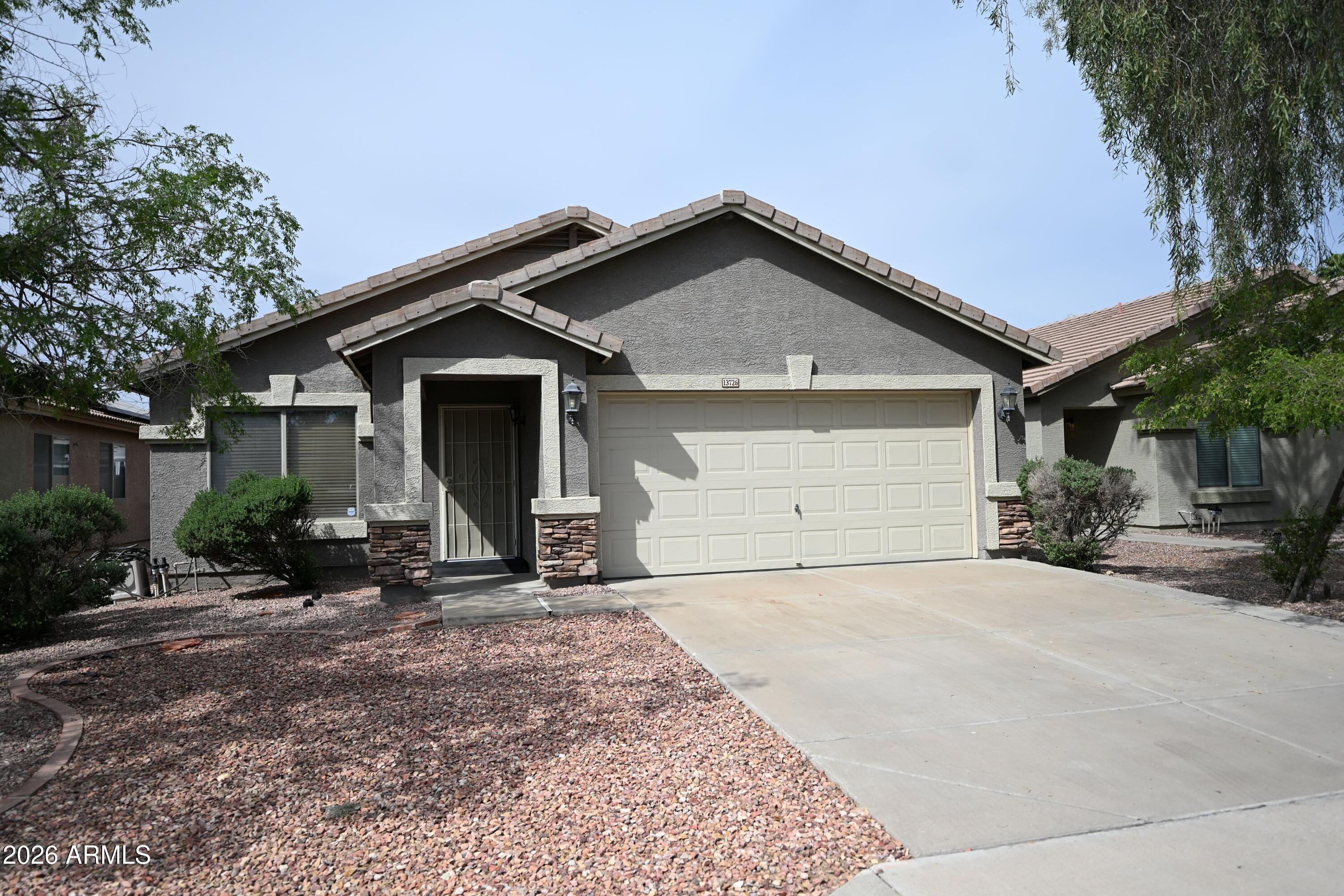 This single-level home with an open floorplan is move in ready. Neutral interior paint and vaulted ceilings make this home feel spacious, welcoming and suitable for any decor. Tiled in the main living area and carpeted in the bedrooms. Kitchen has bar seating and overlooks the great room for inclusive entertaining. Spacious primary suite includes a sitting area and full bath. Nice backyard has a covered patio and fire pit.  Close to Luke AFB, Cardinal Stadium, NASCAR, Spring Training and so much more.