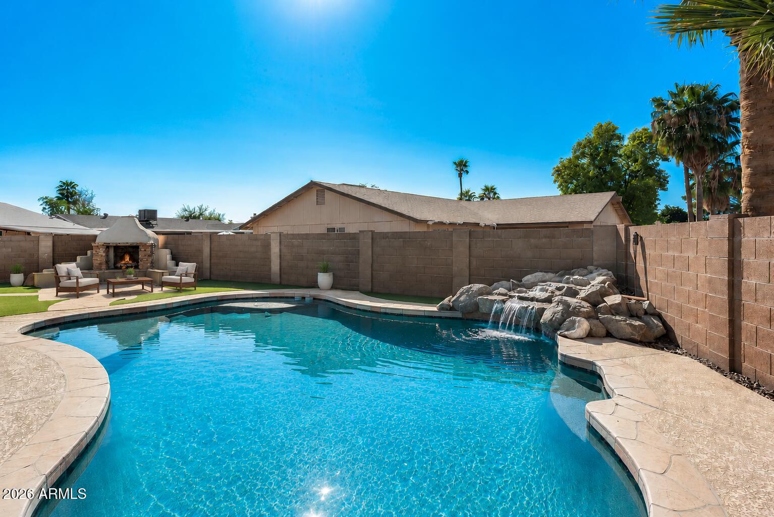 Welcome home to this beautifully maintained 3-bed, 2-bath residence on an oversized corner lot w/no HOA. Thoughtfully designed & exceptionally functional, this home offers the perfect balance of open living & everyday comfort. The spacious great room features a cozy wood-burning fireplace & flows seamlessly into the upgraded kitchen with granite countertops, espresso cabinetry, stainless steel appliances, breakfast bar seating & casual dining. Extensive travertine tile throughout creates a clean, cohesive look with easy maintenance. Step outside to your own backyard retreat featuring a sparkling pool with in-water table & seating, full-length covered patio, & charming outdoor fireplace perfect for relaxing, entertaining, & enjoying Arizona outdoor living with comfort, functionality & value From the moment you arrive, you'll appreciate the pride of ownership and welcoming curb appeal this home offers. The custom front entry and extensive travertine flooring throughout creates an elegant first impression and sets the tone for the warmth and comfort found throughout the home.

Inside, the thoughtfully designed floor plan maximizes every square foot, creating spacious living areas while maintaining the functionality today's buyers desire. Unlike many homes that sacrifice storage and practicality in favor of oversized open spaces, this residence offers the perfect balance of openness, comfort, and everyday livability.

The heart of the home is the great room, where family and friends naturally gather. The adjoining kitchen features granite countertops, extensive cabinet storage, stainless steel appliances, generous prep space, and breakfast bar seating, making it ideal for both daily living and entertaining. The seamless flow between the kitchen, dining, and living areas creates an inviting environment while still providing distinct spaces for each purpose.

The split-bedroom design offers privacy for the primary suite, creating a peaceful retreat at the end of the day. Secondary bedrooms provide flexibility for family members, guests, hobbies, or a home office.

One of the home's most unique features is the outdoor living space. The full-length covered patio, custom bar, and outdoor fireplace create an atmosphere that extends your living area beyond the interior walls. Whether enjoying a quiet morning coffee, hosting friends for an evening gathering, or relaxing under Arizona's beautiful skies, this space becomes a true destination for year-round enjoyment. Least we forget the no maintenance oversized backyard with artificial turf and flagstone-like patio spaces, sparkling pool with in-water table and umbrella, and seating!! Now that's a backyard oasis anyone could enjoy. 

Lastly, the backyard is perfectly thought out with separate pool equipment house, spacious side yards, two pedestrian gates entries, one of which could easily be converted into an RV gate access for flexibility with the oversized corner lot. Additionally, there is a private exit from the Master Suite Bath to the backyard for privacy entrance and exits.  

Located in an established Glendale neighborhood close to shopping, restaurants, entertainment, schools, parks, and major commuter routes, this property offers the convenience buyers seek while maintaining the comfort and charm of a true neighborhood setting.

"This is more than just a house--it's a home designed for gathering, entertaining, and creating lasting memories."
