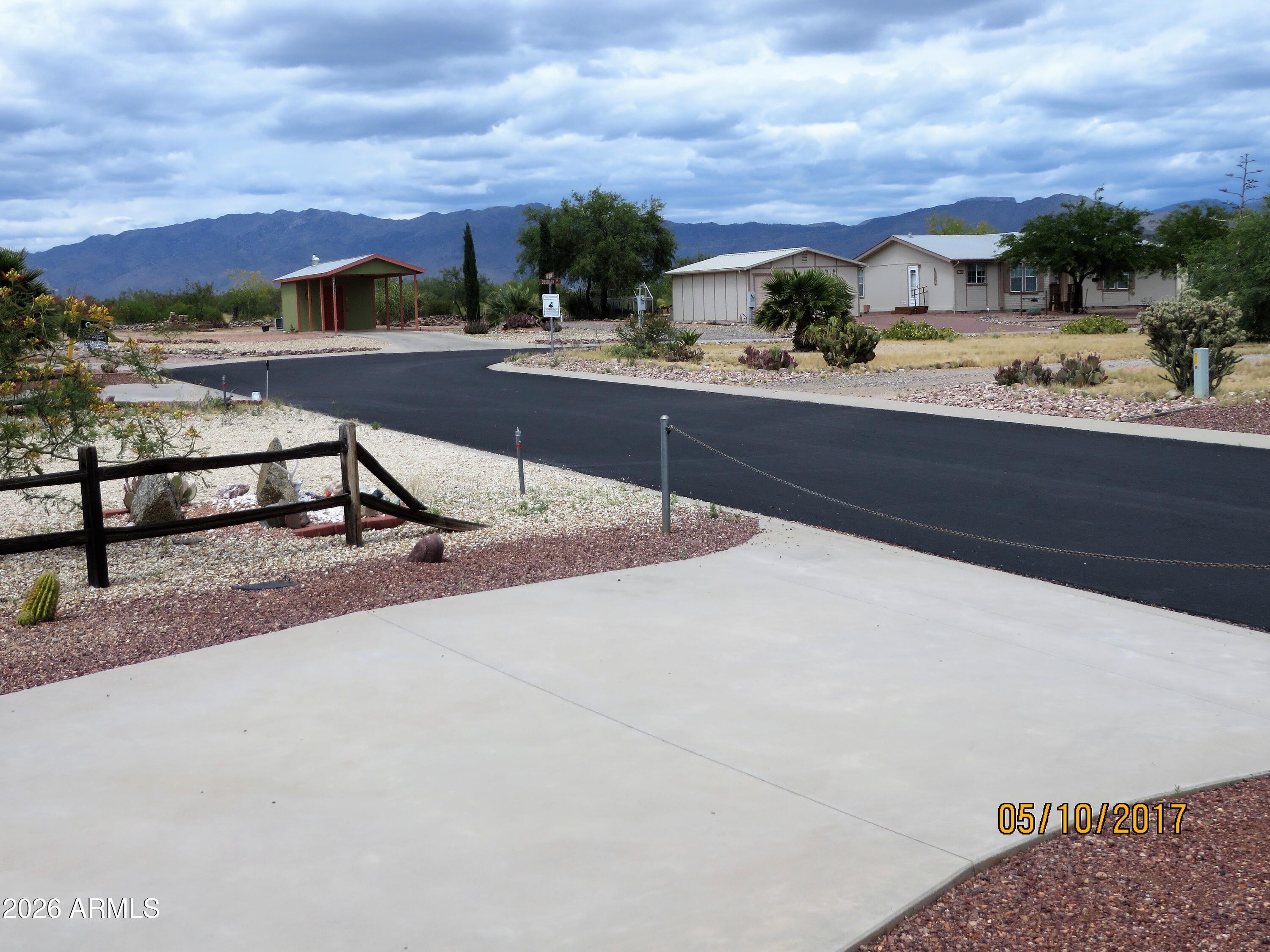 Location, Location, Location with this UPGRADED lot boasting oversized concrete pad and patio with beautiful desert Views. Huge common area at rear of lot affords much privacy, and desert views. Quiet street and very short walk to Saguaro Park. View the sunrises and the sunsets from your perfect RV home base. North Ranch has a clubhouse teaming with activities. Back has gate which opens to miles of adventure hiking and atv trails. Shed for Storage, has bench and washer/dryer.