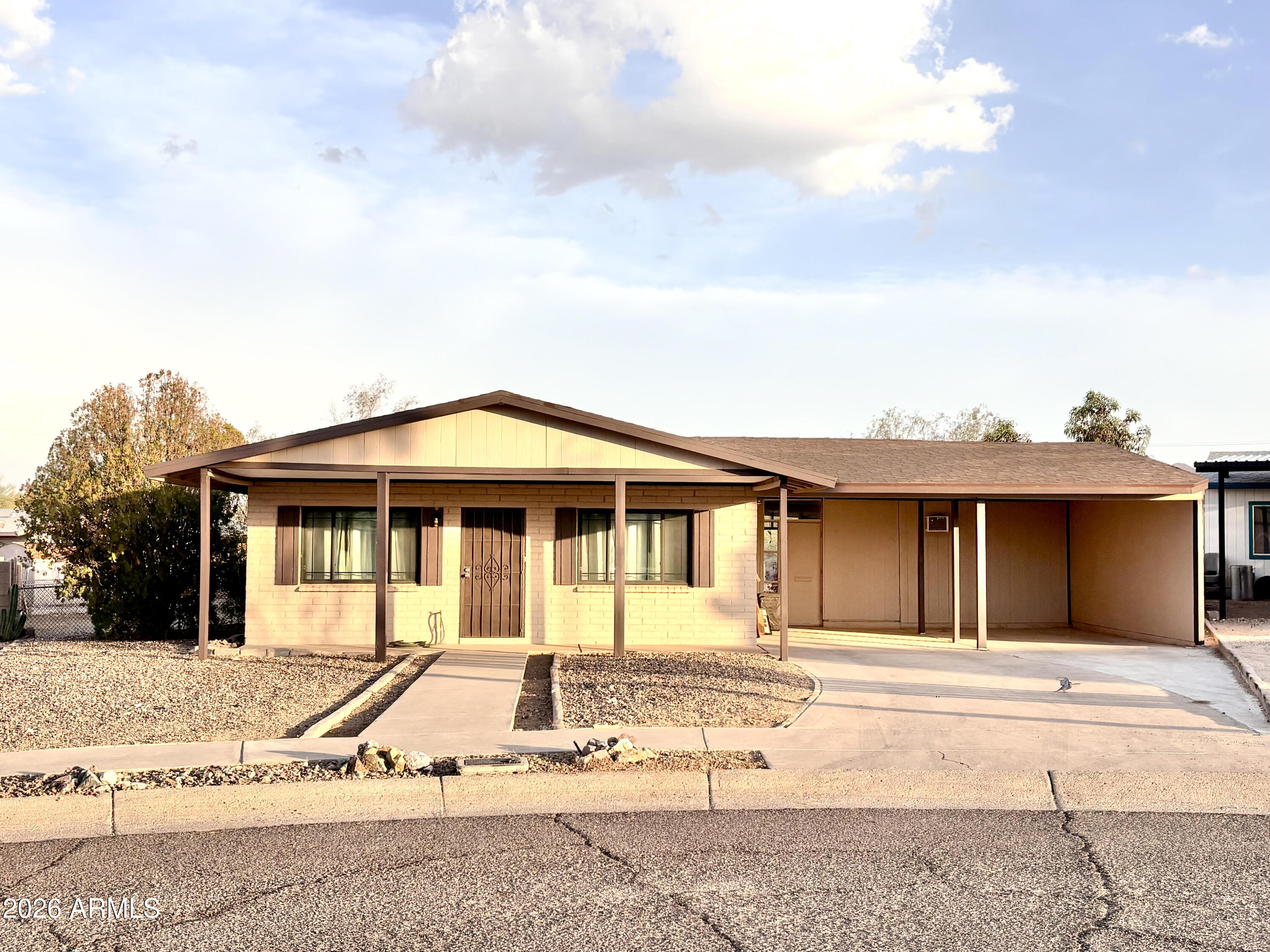 Tucked in a quiet cul-de-sac in Ajo, this slump block 3 bed, 2 bath home sits on a spacious 10,000 sq ft lot with an oversized backyard and minimal traffic--only neighbors pass through. Located near Bud Walker Park, the property offers 1,200 sq ft, central A/C, and covered parking for two. A versatile bonus room behind the garage--currently a gym--adds flexibility for hobbies or workspace. The backyard features a large shop with alley access and a wide bay door. Enjoy Ajo's relaxed desert lifestyle, vibrant art scene, and welcoming community--ideal for snowbirds or full-time living.