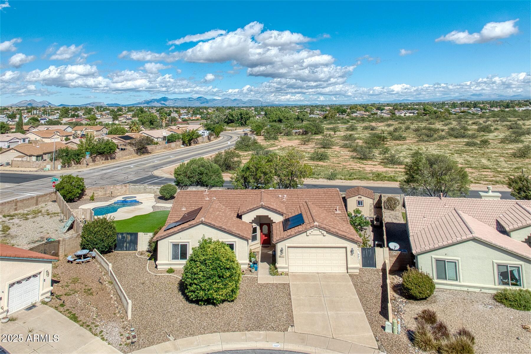 Experience elevated living in this gorgeous 4 bedroom, 2 bath home showcasing a HUGE chef's kitchen with custom cabinetry, expansive counters, and endless storage. Step into your backyard retreat featuring a sparkling pool, soothing spa, and panoramic mountain views surrounded by lush, low-maintenance landscaping. Enjoy energy efficiency with owned solar and an enviable location within walking distance to the elementary school. A perfect blend of sophistication, comfort, and desert beauty!