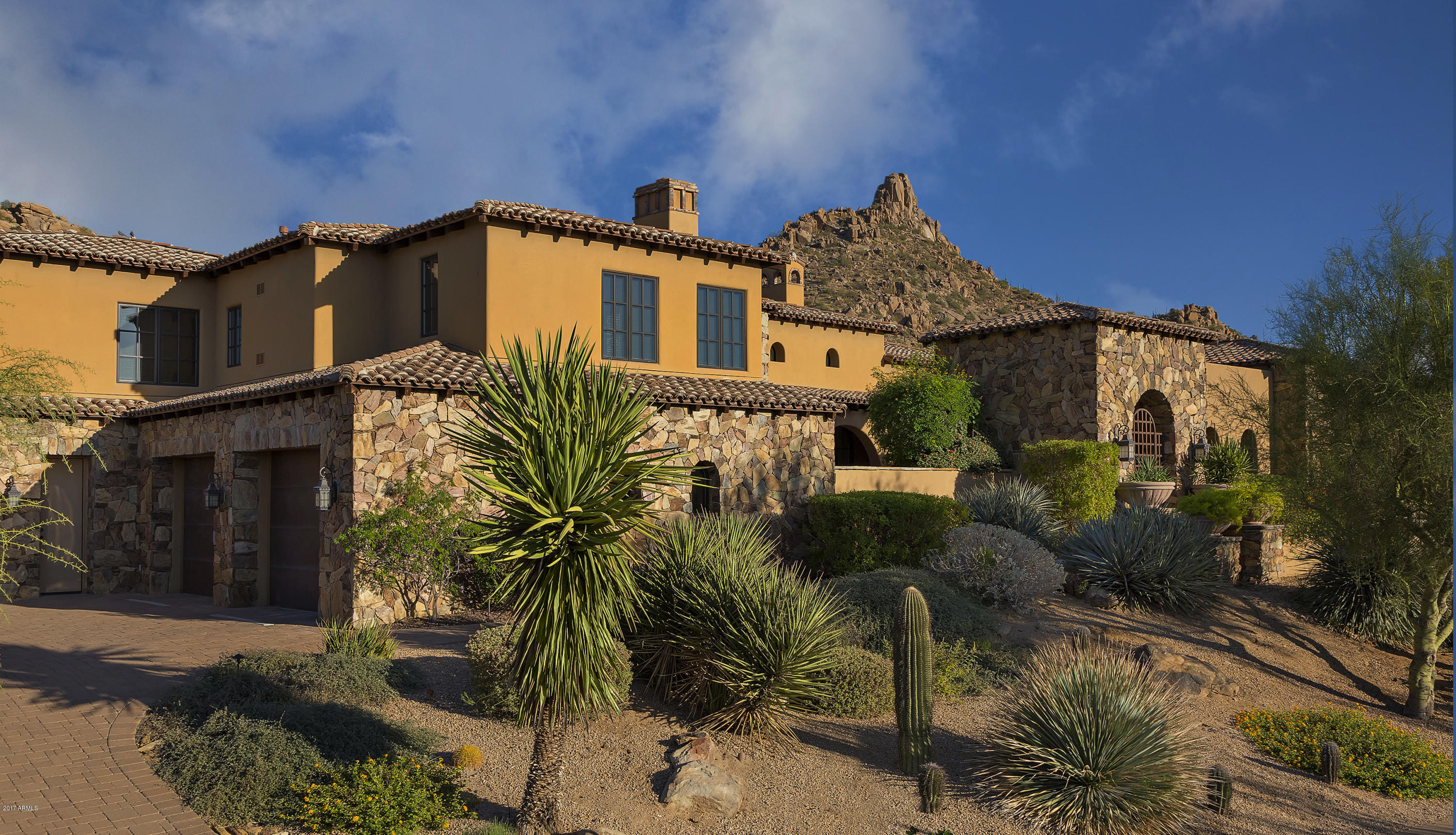 This fantastic custom home, overlooking the 8th green of world renowned Estancia boasts unobstructed views of the fairway and Pinnacle Peak and is truly exquisite in every detail. A soft, contemporary interior design and warm Tuscan exterior makes for a seamless and elegant masterpiece that warms the heart and enhances a true desert living experience. There are numerous outdoor patios such as the large entry courtyard, back patio with 25' wall of glass that pockets away bringing outdoor living into the main body of the home. Private patios off the master bedroom and kitchen further complement the indoor/outdoor design. The interior appointments are masterfully designed and constructed to provide an elegant yet relaxed luxury life style.