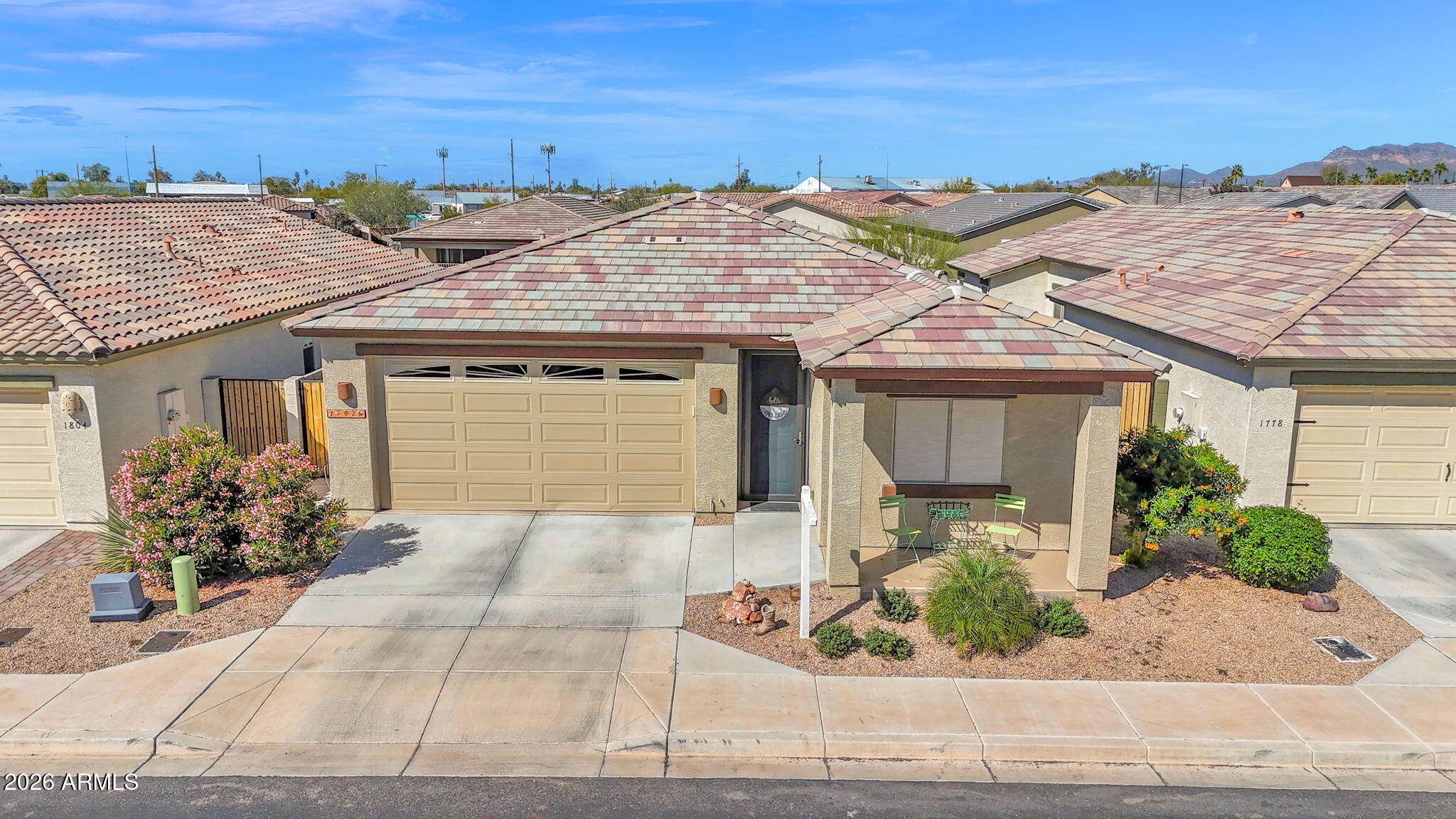 Zero entry from garage with 10 foot ceilings inside home allow for an 8ft garage door, bring your large vehicles. Bel Agave is a gated, active adult 55+community in Apache Junction, Arizona. Built in 2020, this single-level ranch-style home offers a modern desert lifestyle with comfort, functionality, and mountain views all working together seamlessly. Inside, 10-foot ceilings and a bright, open great room layout create an inviting sense of space. The split floor plan with 3 bedrooms, 2 full bathrooms provides excellent privacy, with the primary ensuite set apart as a true retreat.  Well-appointed Kitchen with quartz countertops, stainless appliances, induction cooktop, walk-in pantry, center island, 42 inch cabinets, & reverse osmosis water. Home backs to a wash for privacy, and the the primary bedroom has private back patio access, dual sink vanity, spacious walk-in shower, 2 closets with 1 being a generous walk-in closet. Two additional bedrooms offer flexibility for guests, hobbies, or a home office, served by a second full bathroom finished with the same attention to detail. The two-car garage is a standout, featuring an 8-foot over-height door, epoxy floors, insulated doors, and bonus space for storage, tools or projects. Enjoy mountain views from the patio and take advantage of community amenities including a clubhouse, pool, spa, and pickleball court. Low-maintenance, move-in ready, and thoughtfully upgraded 1792 S Hayley Road delivers the Arizona lifestyle that the 55+ adult community of Bel Agave is known for.