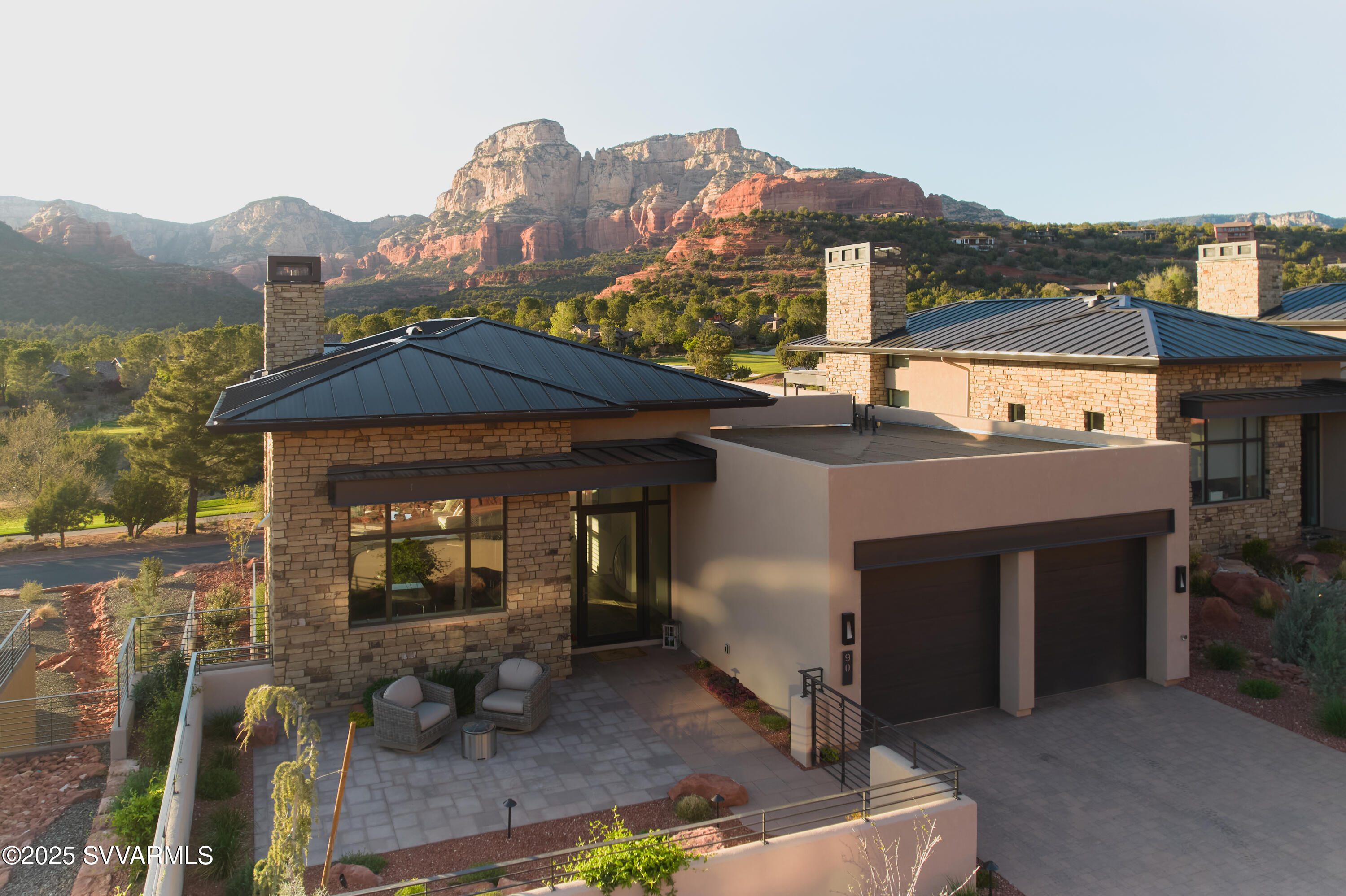 Indulge in the ultimate Sedona lifestyle with this fully furnished luxury retreat at Seven Canyons. Nestled along the famed Tom Weiskopf-designed course, this 3,500 sq ft contemporary residence captures unobstructed breathtaking red rock and sweeping panoramic views. Designed for elevated living, enjoy a grand great room with soaring 14' ceilings, a stunning chef's kitchen, and a private primary suite on the main level. Every detail exudes sophistication, from automatic window coverings to energy-efficient systems. Step outside to a serene covered patio, built-in BBQ, and access world-class club amenities. A coveted Seven Canyons Golf Membership is included (buyer to pay $18,000 transfer fee). Gated privacy, unrivaled scenery, and refined elegance—this is your dream lifestyle property.