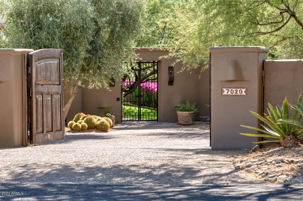 Gated Private 1.25 Acre Estate on the Paradise Valley Country Club Golf Course! Expertly designed by architect Bill Tull, this home is an incredible blend of sophistication and comfort. The private courtyard opens to the lush grounds and unparalleled VIEWS to the perfectly manicured Fairways and the surrounding Mountains. This Modern SW Gem features rare Sabino wood cabinetry, custom carved interior wood doors, and massive beam ceiling details. Spacious open floor plan includes disappearing walls to both the front and back patio areas, massive great room open to dining and family rooms, and extraordinary chef's kitchen with Camelback VIEWS, new appliances, custom island, wine fridge. The luxurious master suite features separate his and her bath areas with all new finishes throughout: Travertine accents, custom lighting, new jetted tub and 2 huge closets with skylights, and an Office. The 3 En-suite bedrooms and separate office all open to outdoor patios. The upstairs leads to a private loft and guest suite with its own balcony and outdoor stairway leading down to the sparkling all-tile pool and spa with waterfall and fireplace sitting area.