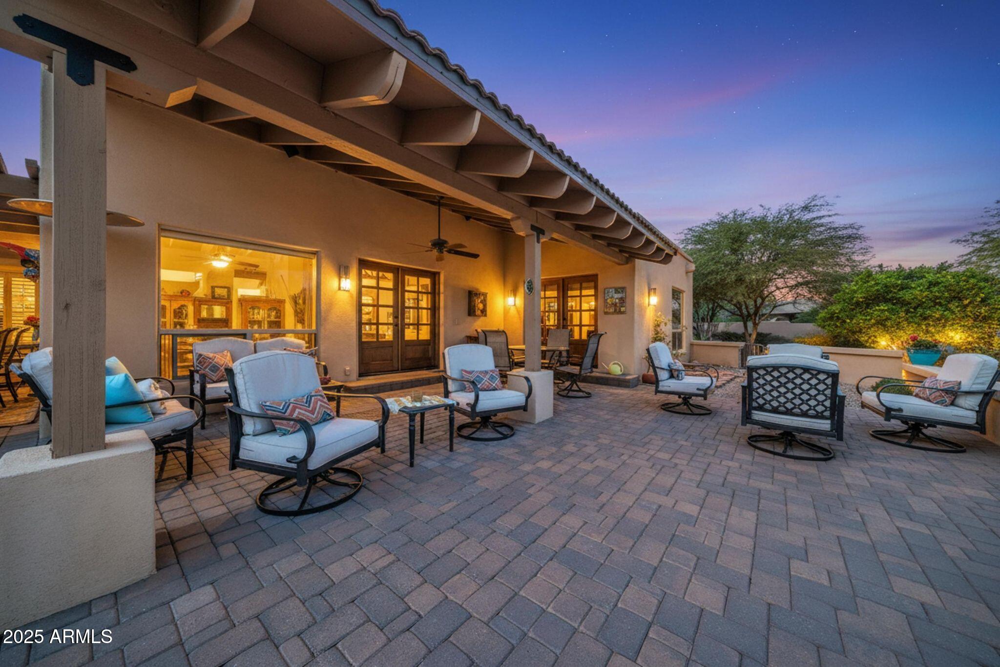 Charming Spanish-style beauty blends timeless architecture with warm, inviting  living spaces.  Great room, Vaulted ceiling with wood beams, Saltillo flooring, and Kiva fireplace. The kitchen includes stunning granite counters, gas cooktop, and a walk in pantry.  Two dining areas w/ patio access.  Spacious Primary suite includes a relaxing sitting area and French Doors to the patio.  The spa-like bathroom has a soaking tub, travertine walk-in shower, plus a closet to die for.  Guests will enjoy the cozy guest bedroom and bath.  Den/office/3rd bedroom gives you options.  Laundry and powder room are adjacent to the kitchen and 2 car garage. The tranquil outdoor space has latillos for shade, wood burning Kiva fireplace, mature landscaping and a view of Four Peaks. Come and see!