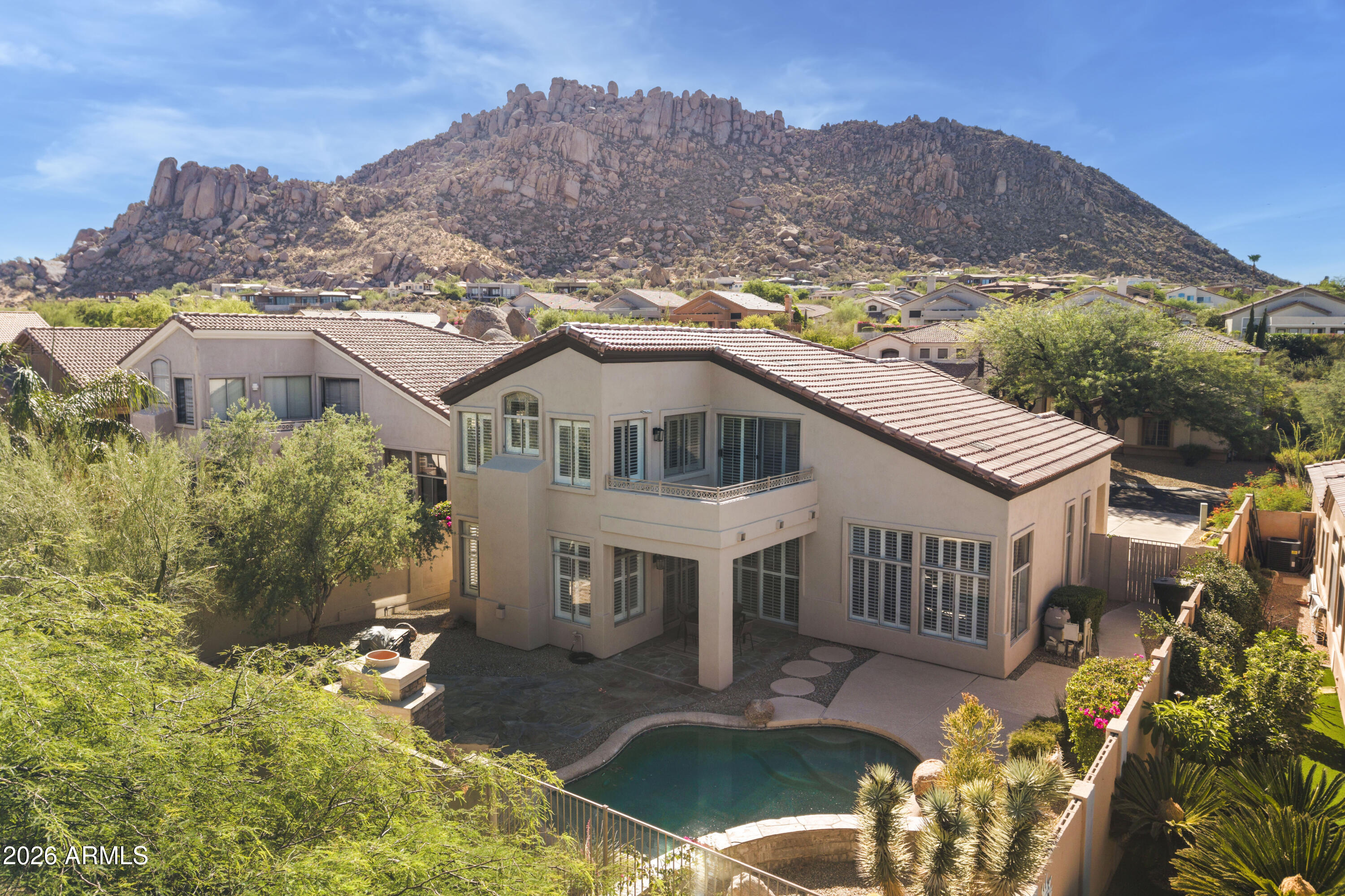 Fully renovated 3BD/2BA in Troon Village with mountain views & a pool that backs to the Sonoran Desert. Kitchen features custom oak cabinetry, quartz waterfall island, double wall ovens, & 6-burner gas cooktop. The primary bathroom is built around a freestanding soaking tub set against floor-to-ceiling charcoal zellige tile with brass fixtures. Dual sinks and large walk in closet. A stone gas fireplace anchors the living room, vaulted ceilings throughout, plantation shutters, & a built-in bar with wine fridge, moroccan tile, & marble counters. Private pool, outdoor fireplace, built in BBQ & covered patio & no rear neighbors. 2-car garage. Minutes from Pinnacle Peak tr, the Four Seasons, & top dining along N Pima Rd. Roof Tile and underlayment replaced 2026, AC '24 & 18