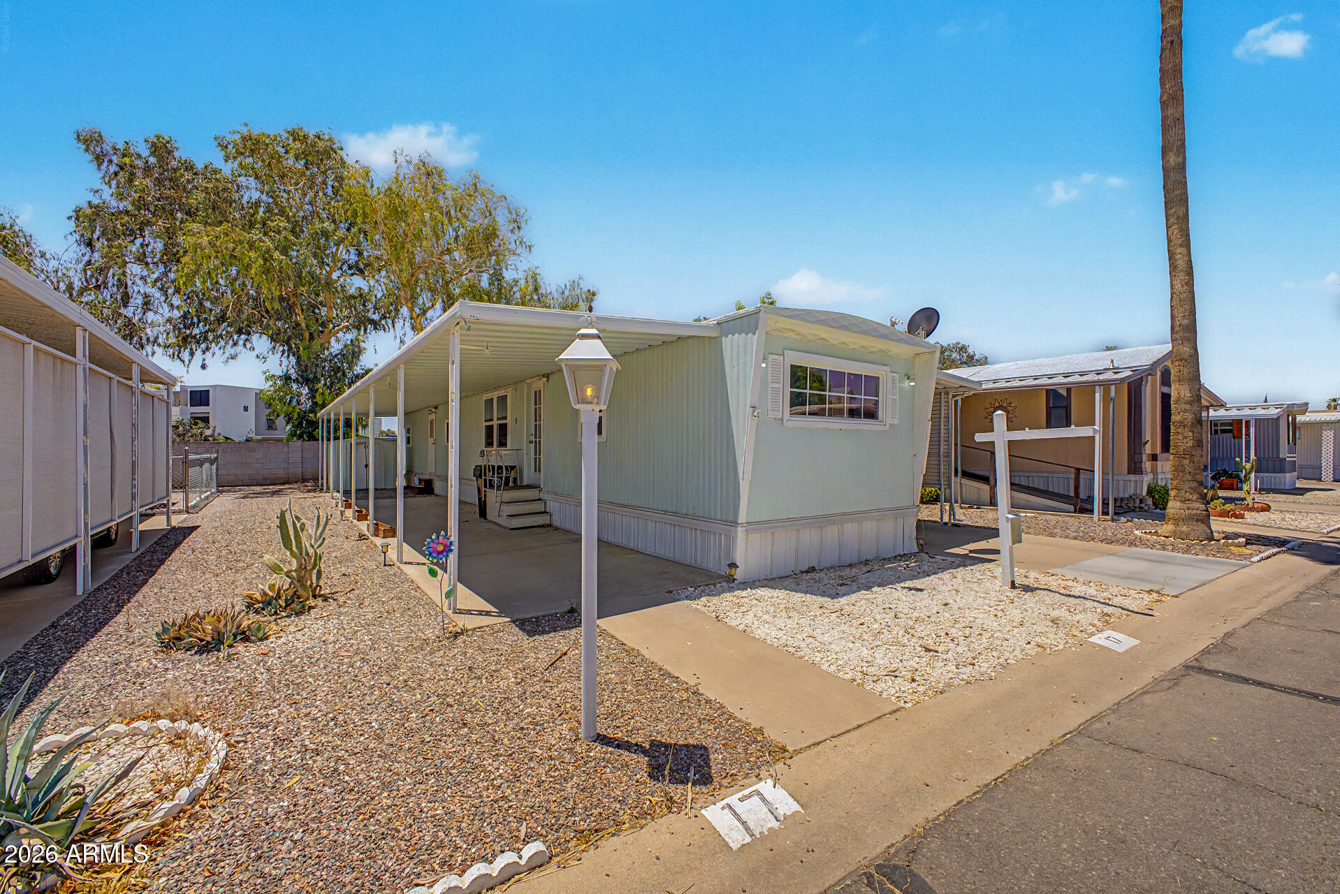 Beautifully updated in 2023, this move-in ready 2-bedroom, 1-bath home is located in one of Mesa's best-kept secret age-qualified communities! Thoughtfully remodeled with modern finishes and accessibility features throughout, this home offers comfort, convenience, and exceptional value.
Recent upgrades include drywall throughout, laminate flooring, dual pane windows, canned lighting, updated outlets/receptacles, ceiling fans, and a fully remodeled kitchen featuring granite countertops, stainless steel appliances, updated hardware/fixtures, and a tankless hot water heater. Bathroom updates include a walk-in shower with grab bars for added accessibility. Additional highlights include a Semper Fi A/C system and included washer & dryer. Conveniently located near the Light Rail with direct Conveniently located near the Light Rail with direct access to Downtown Mesa, Tempe, and Phoenix. Only a short distance from Mesa Riverview, Tempe Marketplace, Cubs Spring Training, Phoenix Rising Stadium, ASU sporting events, Salt River Fields, Scottsdale Fashion Square, and Phoenix Sky Harbor Airport.

Community lot rent is $800/month.

An excellent opportunity for affordable living in a prime location with extensive upgrades already completed!