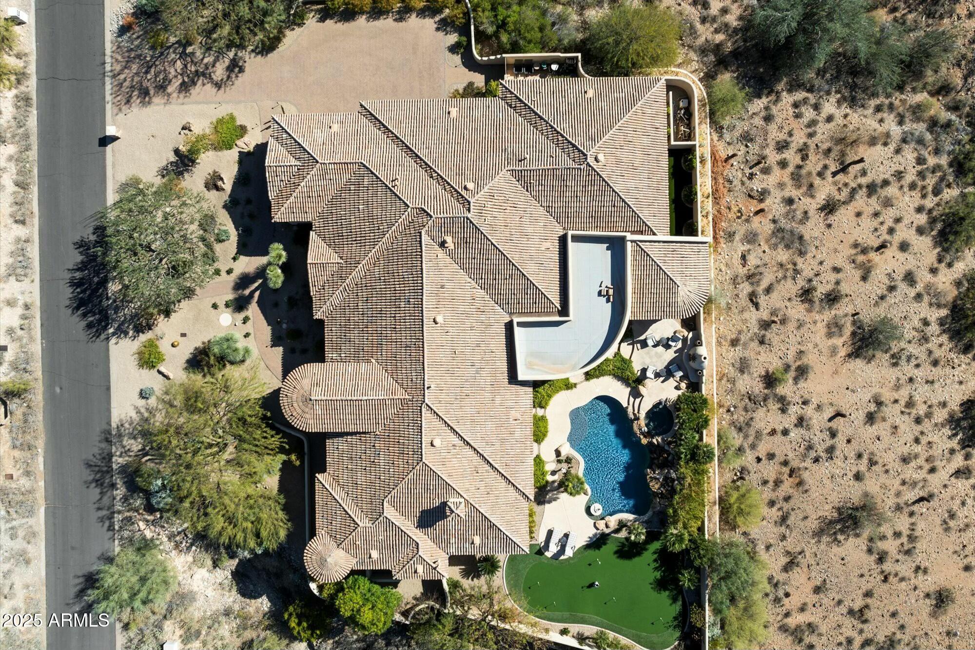 Seeking a private retreat with City Light and  Camelback Mountain Views?  Look no further than this custom built Single-level entertainer's paradise.  Thoughtfully designed split floorpan with great room concept. Seamlessly entertain indoors and outdoors. Top of the line Expansive Kitchen: Double Islands, Open to Great Room, Wet bar and Wine Cellar. Truly a Resort-like backyard, lighted putting green, heated pool & Spa.  In Home Movie Theater for Sports or Action Movies.  All En suite Bedrooms. Office too. Large Laundry Room. Stunning mountain and city light views.  Host Large Parties and/or Relax with Friends & Family. Close to Mayo Clinic, highly rated  BASIS and Desert Mountain High Schools (IB International Baccalaureate program).  You've got to see.  Reach out with questions. Primary Suite includes sitting/workout area, spa-like bathroom.  At the east end of the property, enjoy a second primary suite with private exit to backyard, two other guest rooms, + office (could be added bedroom) and your private movie theater complete with recliners and perfectly designed acoustics.   Outdoors provides your own private paradise with a heated outdoor kitchen, heated pool and spa, water fall, lighted putting green, fireplace and additional conversation areas for year-round enjoyment.    Control 4 app runs the smart home automation systems.  This private luxury retreat enjoys close proximity to world-class Mayo Clinic, some of Scottsdale's newest, popular restaurants and a tranquil desert setting for enjoying Scottsdale's beautiful outdoors.Looking to make your own rules?   No HOA here to be bothered with. 
Recent investments:  Backyard Outdoor Kitchen, New Landscaping Front & Back, Appliances, Paint Interior & Exterior, New HVAC's, security cameras and monitored security system.