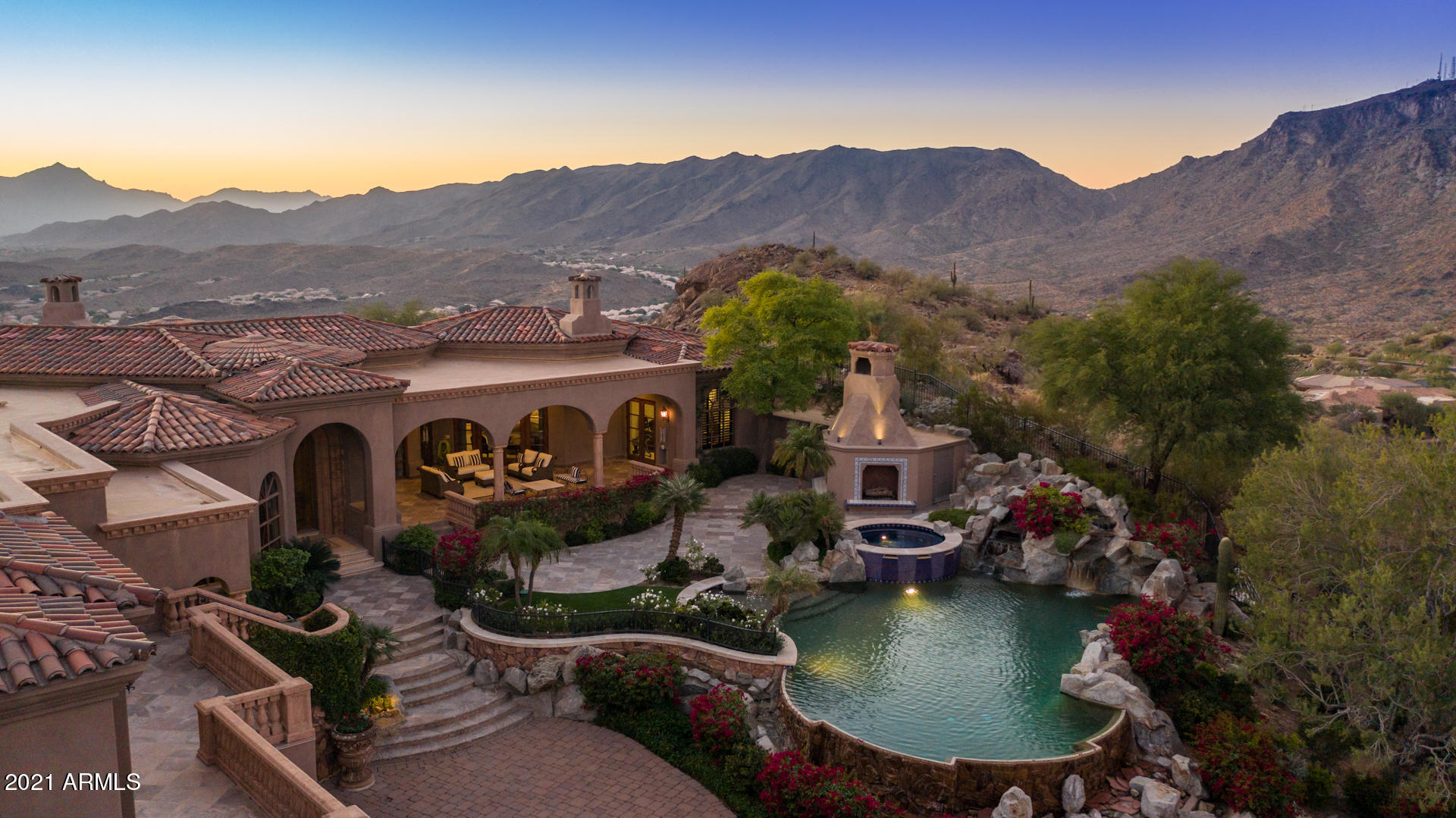 This private mountaintop custom estate in the luxurious gated community of Tapestry Canyon is an absolute must see.  This one of a kind property sits on a exclusive 3.343 acre electronic gated private lot for ultimate privacy, while enjoying unobstructed panoramic city and mountain views. Pillow limestone flooring, granite counters, hand crafted chandeliers, and custom cabinetry  throughout entire home!! Gorgeous gourmet kitchen featuring walls of hand crafted custom cabinetry, granite countertops, built-in refrigerator and freezer, custom dry bar, breakfast bar, breakfast room, large kitchen island, stainless steel wall ovens, microwave drawer, refrigerator freezer drawers, and freestanding Viking propane stove 
Fabulous foyer with domed ceiling opens to huge formal living room with fireplace and formal dining room. Family room features stone fireplace, high ceilings for a cozy night in, or entertaining guests. Marvelous master bedroom suite with private covered patio with stunning city and mountain views! One of a kind master bathroom with spa-like tub area, dual vanities with granite counters and custom cabinetry, huge walk-in shower and gigantic walk-in closet with custom built-in shelving, racks and washer/dryer hook up. Private master gym with city views.   Two elegant spacious bedroom en suites each with custom bathrooms and spacious walk-in closets.  Fully equipped guest/ in-law  suite with private kitchen.   Large diving play pool with waterfall spill-way, and slide. Multiple large covered patios including outdoor dining area with built-in BBQ. Spacious covered patios with beautiful fireplace to sit and enjoy the panoramic city and Mountain View's. Large grass areas. 
Panoramic Private Mountain and City Lights views from entire property!!!  Large inside laundry room with granite counters and plenty of custom cabinetry for storage . Oversized 10 car extended length garage with built in storage cabinets. This home truly is one of a kind at the top of the Tapestry Canyon  in a secluded cul-de-sac. Great Ahwatukee Location!! Award Wining Kyrene Schools.   Detailed Amenity List available in document section.