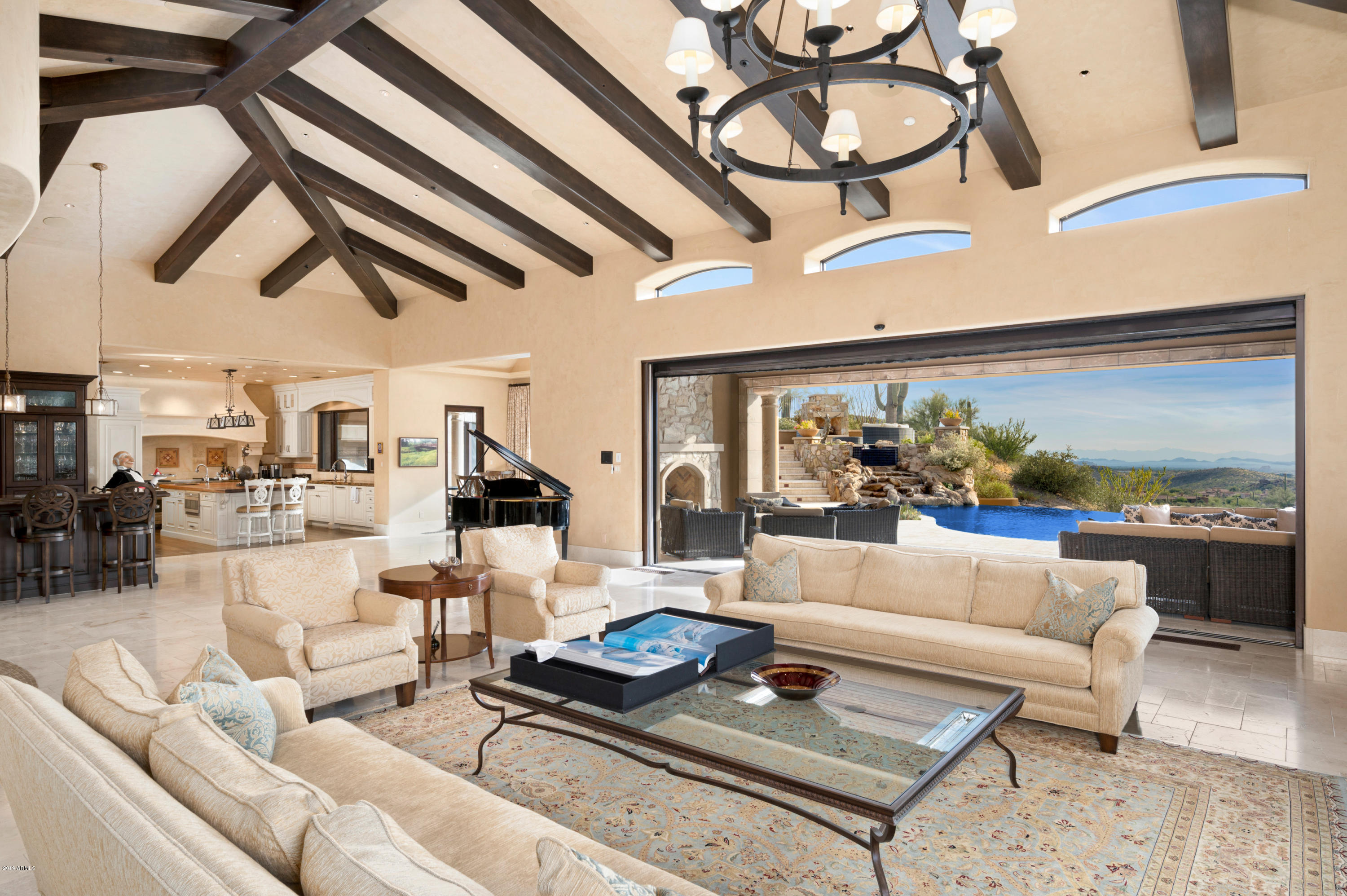 Sophisticated custom estate, overlooking the 16th hole of Chiricahua golf course in the prestigious, community of Saguaro Forest in Desert Mountain. Single-level living with an open floor plan, AMC-style theater and billiard game room. Grand room with telescoping glass walls opening to expansive deep-covered outdoor living area with multiple fireplaces, alfresco dining, pool, waterfall spa, sprawling sundeck with beautiful city lights, sunsets, fairway and mountain views. Master Wing with coffee bar, dual master closets, safe room, adjoining dual baths, fireplace and private patio. Exquisite Guest Retreats with coffee bar and beverage captains, an Exercise / Flex room with private patio and Two Executive Offices-one with an Eagle-Nest loft desk area, 2-bedroom Guest House and 6 Car Garage. Garage

En Suite Bedrooms | Custom built 2012 | Gourmet Kitchen | Wolf French Gas cook-top with double full-size oven | 2 Wolf Warming Drawers | Subzero Full-Size Fridge/Freezer| 2 Refrigerated Under-Cabinet Drawers | Walk-in Pantry | 900+/-Bottle Wine Room | Full-Service Wet Bar | Wine Captain | Butler Pantry | Soaring Ceilings | Hardwood & Travertine Floors | Smart Home with Cameras | Crestron System | Owned Solar Panels | Negative-Edge Pool and Waterfall Spa | Pool Bath | Outdoor Living Areas with In-ceiling Heaters | 

*Desert Mountain Membership is not included with sale, but may be purchased through Desert Mountain Club Services