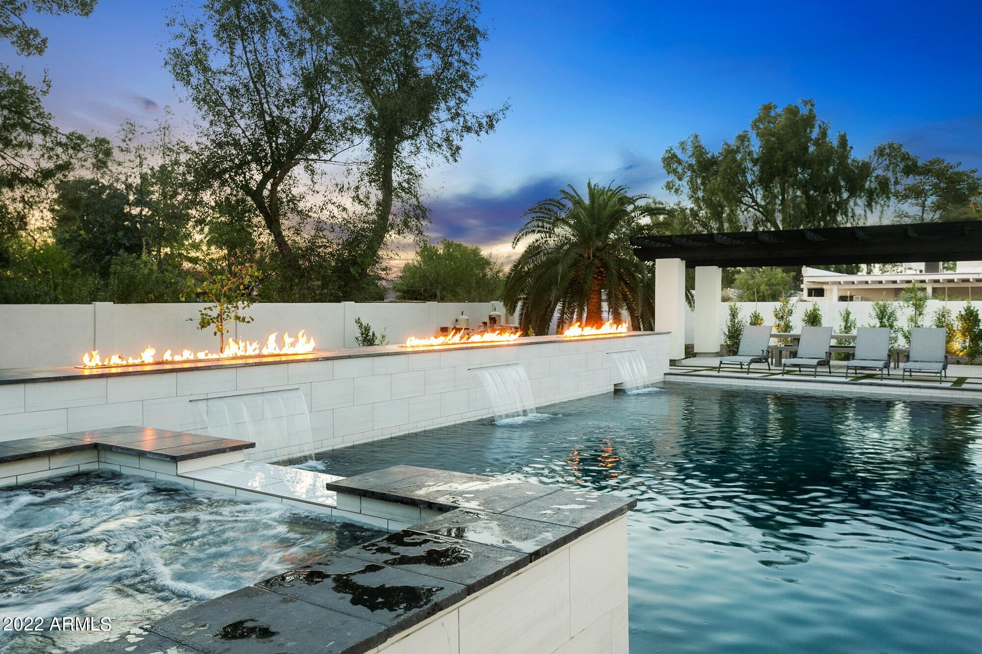 This warm and welcoming property has it all! It boasts 4+ bedrooms with en-suites and an additional half bath. Bonus room is currently being used as a 5th bedroom. A well designed home that's newly renovated and features some of the finest interior finishes and outdoor amenities you will find in the heart of North Scottsdale. Comfort and design are beautifully blended in this open concept kitchen and living room which connect seamlessly to the resort-style exterior living space through a custom 20 foot slider! This split floor plan has hardwood floors, high-end tile, designer lighting, and soft-close cabinets throughout. Kitchen features stainless steel appliances, expansive walk-in pantry with an additional refrigerator. NO HOA