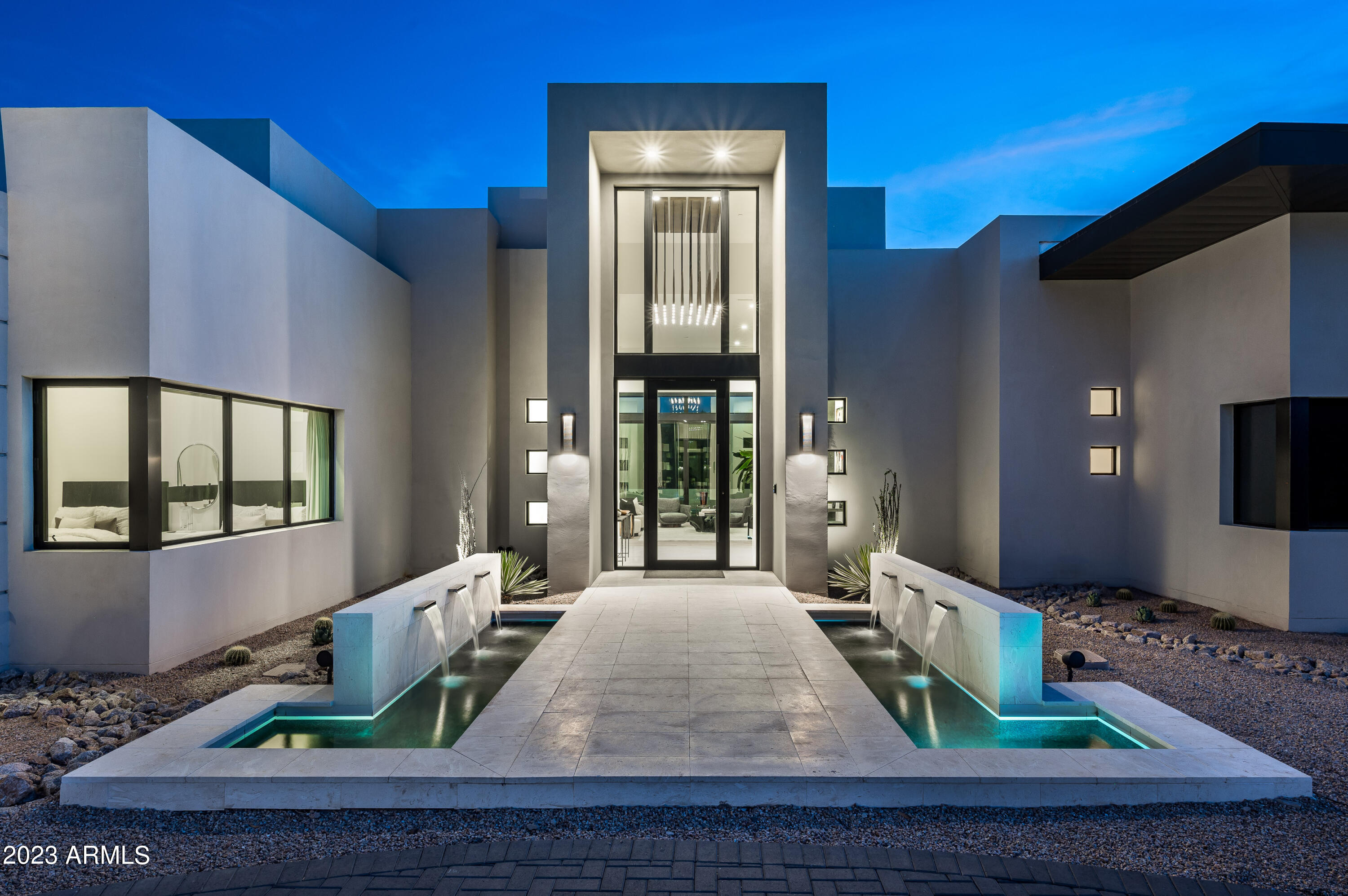 Welcome to Paradise Valley, where luxury living reaches new heights. Nestled amidst the breathtaking landscapes of Arizona, this extraordinary 2021 custom built estate presents the epitome of elegance and grandeur. Awe-inspiring from every angle, this modern luxury real estate gem offers an indulgent sanctuary for those seeking the ultimate in refined living and privacy.
Situated on over an acre of land, this magnificent privately gated property boasts an exquisite main residence that encompasses 4 bedrooms and 5 opulent bathrooms. Every detail of this architectural masterpiece has been meticulously crafted to offer a harmonious blend of sophistication and comfort.
As you step through the entrance, you are immediately captivated by the grandeur that surrounds you. The interiors are adorned with high ceilings, intricate moldings, and radiant natural light that bathes the living spaces. The spacious gourmet kitchen, a haven for culinary enthusiasts, is equipped with top-of-the-line appliances, custom cabinetry, and a center island that is perfect for both casual meals and grand gatherings.
The master suite, an oasis of serenity, beckons you to unwind in luxury. Offering a private retreat, it features a lavish en-suite bathroom with dual vanities, a soaking tub, a walk-in shower, and an abundance of closet space. The additional bedrooms each offer their own en-suite bathrooms, providing privacy and comfort to family members and guests alike.
Beyond the main residence, this estate boasts a remarkable six-car garage, providing ample space for car enthusiasts to showcase their collection. A haven for entertaining, the outdoor living areas are equally as impressive. Lushly landscaped ficus trees envelop the sparkling pool and spa, along with the entire perimeter of the home, creating a resort-like ambiance and providing the estate with ultimate privacy. The covered patio invites al fresco gatherings that are perfect for enjoying the idyllic Arizona weather.
To ensure the utmost comfort and privacy for guests, a fully appointed guest house awaits just steps away from the main residence. This guest house offers a complete retreat, with its own kitchen, living area, bedroom, and bathroom. Visitors will relish in the luxury and convenience this separate dwelling provides.
Paradise Valley is renowned for its idyllic surroundings and exclusive lifestyle, and this luxury real estate offering epitomizes the essence of this coveted locale. With its unparalleled amenities, exquisite finishes, and breathtaking views, this estate is a testament to the finest in luxury living. Prepare to be enchanted as you experience the pinnacle of elegance in this Paradise Valley masterpiece.