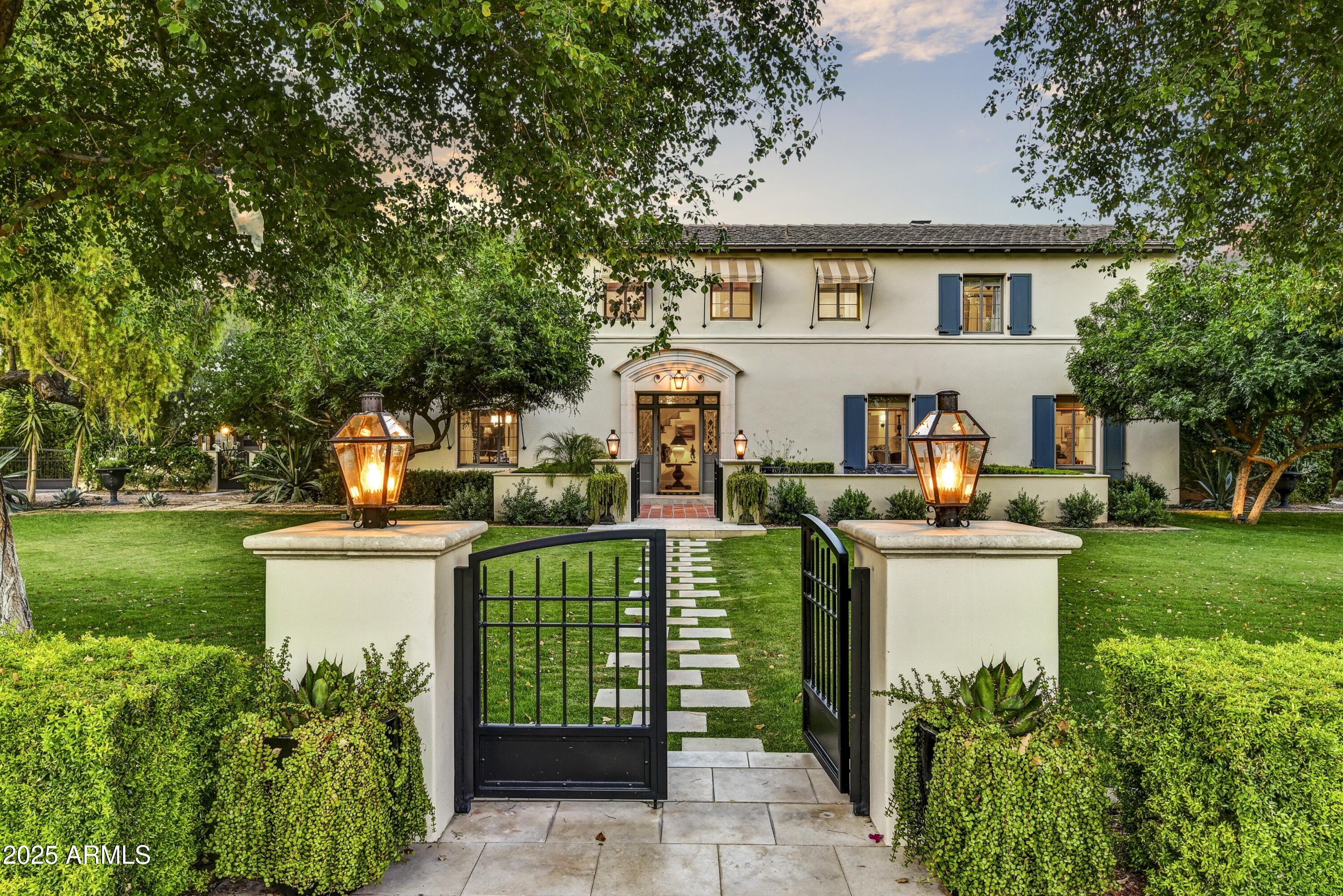 Tucked gracefully behind lush landscaping and framed by mature trees, this exceptional Mediterranean estate captures the essence of enduring beauty, quiet sophistication, and effortless luxury. Thoughtfully reimagined and masterfully remodeled, the residence achieves a rare harmony between old-world character and modern refinement—where timeless architecture meets today's elevated lifestyle.
Inside, a serene palette of soft, natural tones and designer-selected finishes creates a sense of calm and understated elegance. Formal living and dining rooms pay homage to the home's heritage, while the reimagined gourmet kitchen—anchored by premium appliances, bespoke cabinetry, and an expansive island—opens seamlessly to a spacious family room.  Walls of glass invite natural light and frame serene garden views, creating a perfect setting for intimate gatherings or grand entertaining.
A flexible main level offers thoughtfully designed spaces, including a handsome den, a private office or guest bedroom, and a secondary prep kitchen with laundry for effortless hosting. A charming guest suite, secluded with its own private entrance, offers an exclusive haven for visitors or extended stays.
Upstairs, the primary suite is a sanctuary of tranquil luxury. Dual walk-in closets with custom millwork, soaring ceilings, and a spa-inspired bath clad in marble and limestone elevate the sense of indulgence. A freestanding soaking tub and oversized Walker Zanger tile shower complete this serene retreat. Two additional en-suite bedrooms provide comfort and privacy for family or guests.
Outdoors, the home reveals its most enchanting moments. Designed for year-round enjoyment, the East-facing backyard captures soft morning light and evening breezes, offering a true extension of the living space. Swim beneath the sky in the elegant pool, gather around the firepit as dusk settles, or wander through the herb and vegetable gardens. Multiple patios, two calming water features, a sport court, and inviting lounge areas allow for both intimate escapes and lively entertaining.
Even the practical details are executed with the highest level of craftsmanship. The fully remodeled two-car garage reflects the home's thoughtful design, while a custom steel pergola provides additional covered parking with architectural finesse.
This is more than a home, it is a lifestyle defined by timeless style, curated comfort, and quiet grandeur. A rare opportunity to own a residence where exceptional design, enduring elegance, and modern-day sophistication converge in perfect balance.