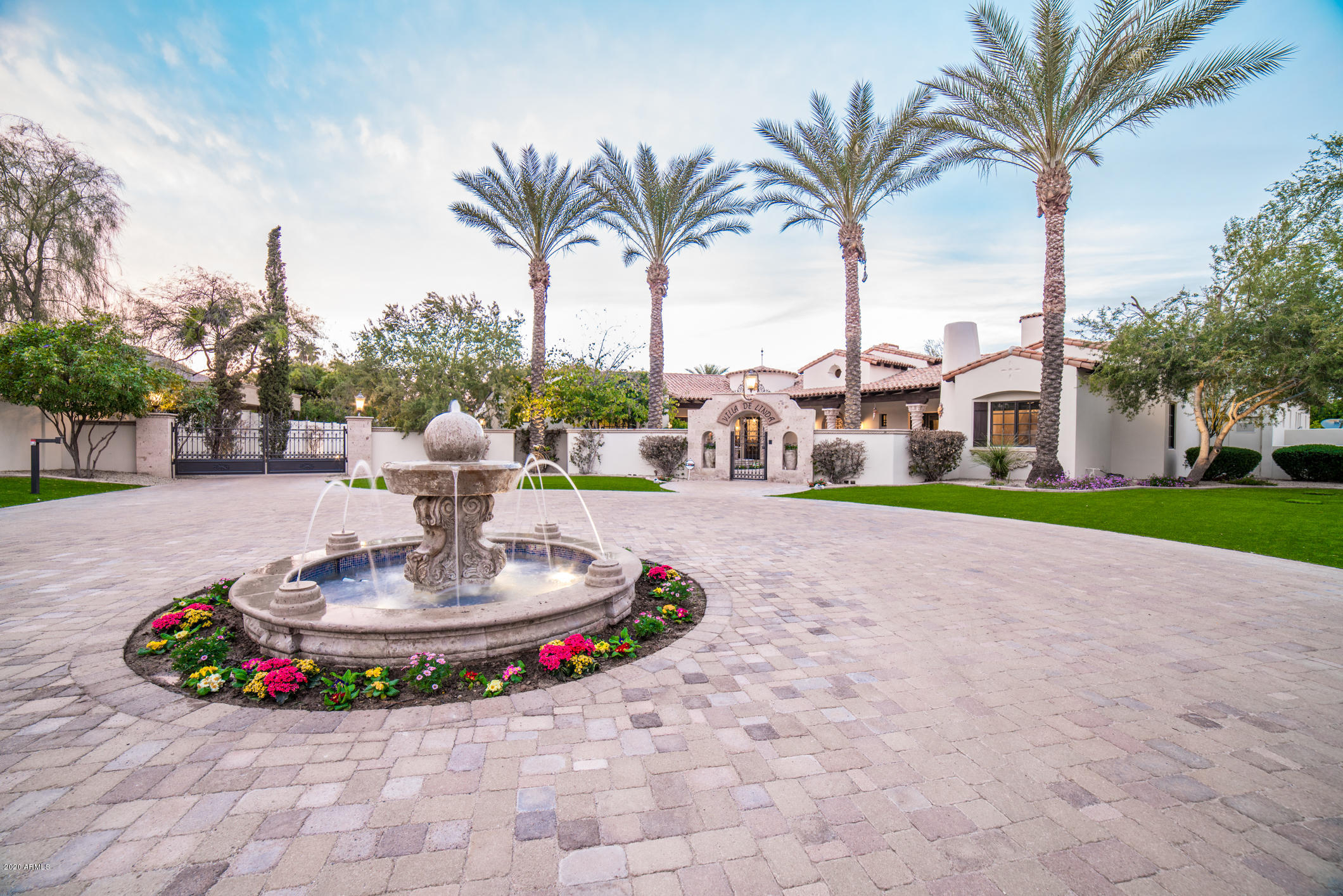 Exceptional Resort style Spanish Villa with gorgeous mountain views in the heart of Paradise Valley. Prime location allows easy access to Scottsdale, airports, fine/casual dining and entertainment venues. Formal entry greets you with rich stone and vaulted ceilings that complement one another. Astonishing kitchen with all high end appliances gas range & griddle, warming drawers, wine cellar & two butler's pantries. Exclusive master wing w/private entrance, ample views of mummy and camelback mountain, fireplace & private courtyard. Breathtaking living area with a pocket door connecting the interior to the exterior. Finely manicured resort style backyard and breathtaking mountain views featuring negative edge pool and heated spa, cabana, sport court, ramada & outdoor fireplace/grills.